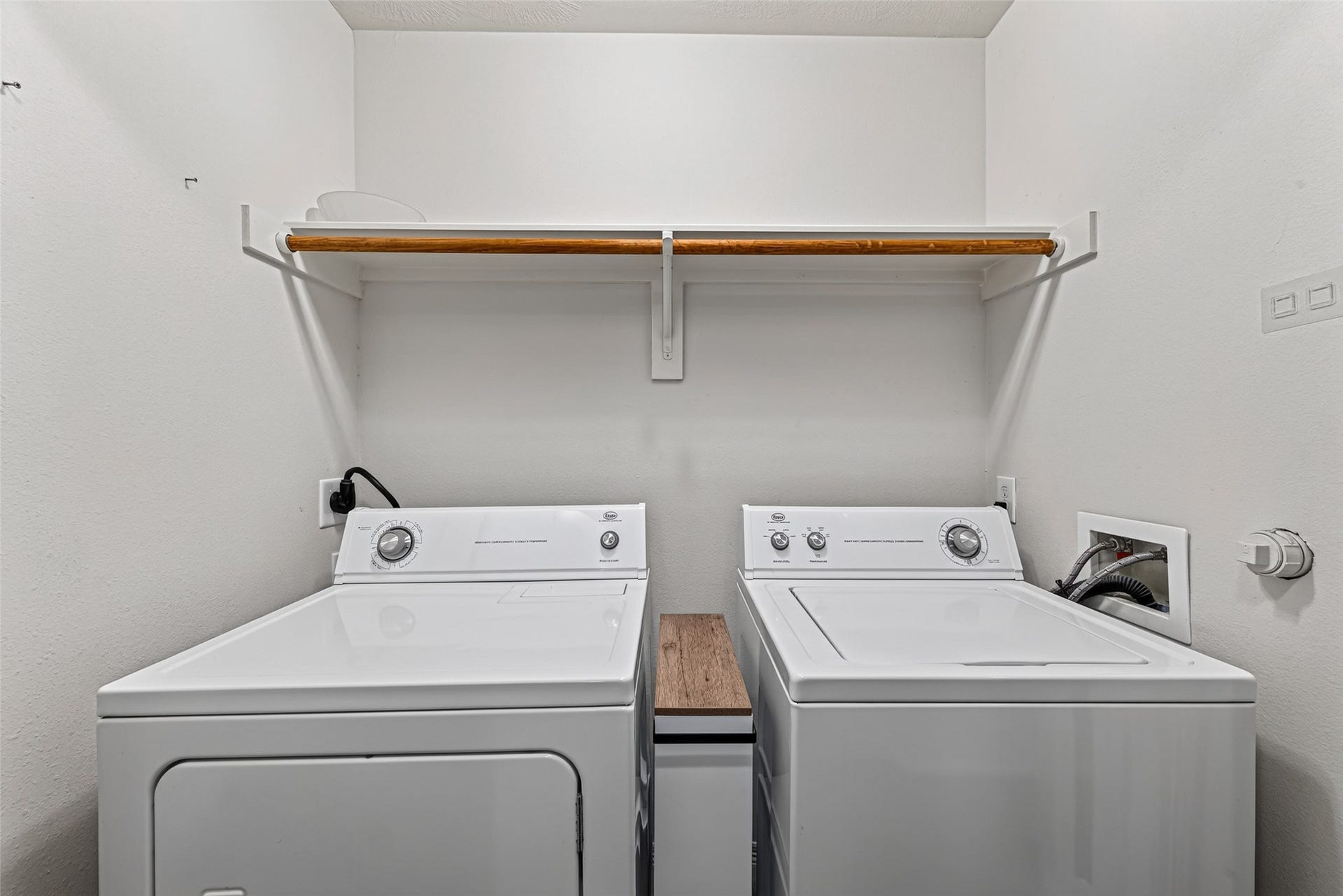8910 Minola Oaks Drive, Houston, TX 77064 Laundry with washer and dryer, shelves, and hanging rod is upstairs near the bedrooms.