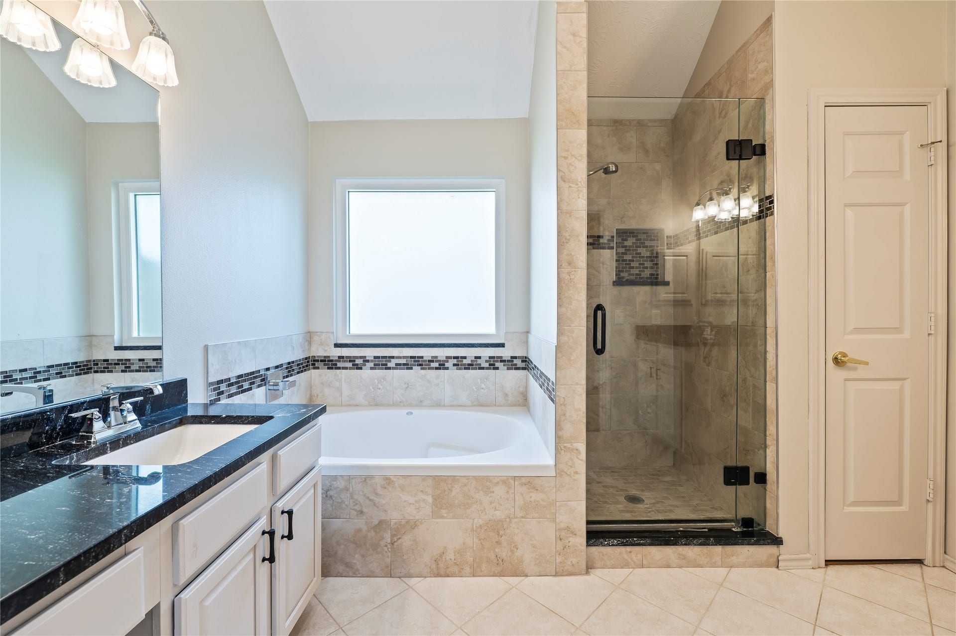 2009 Stapleton Drive, Friendswood, TX 77546 Large tiled tub area with walk in glass door shower.