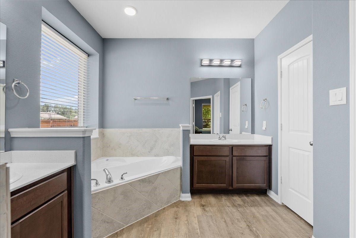 28619 Riverside Crest Lane, Huffman, TX 77336 Unwind in the soaking tub and enjoy a bright primary bath filled with natural light.