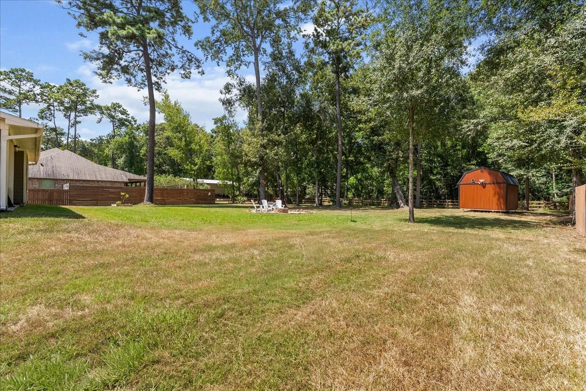28619 Riverside Crest Lane, Huffman, TX 77336 Mature trees and an impressive amount of open yard give you the country feel you've been looking for.