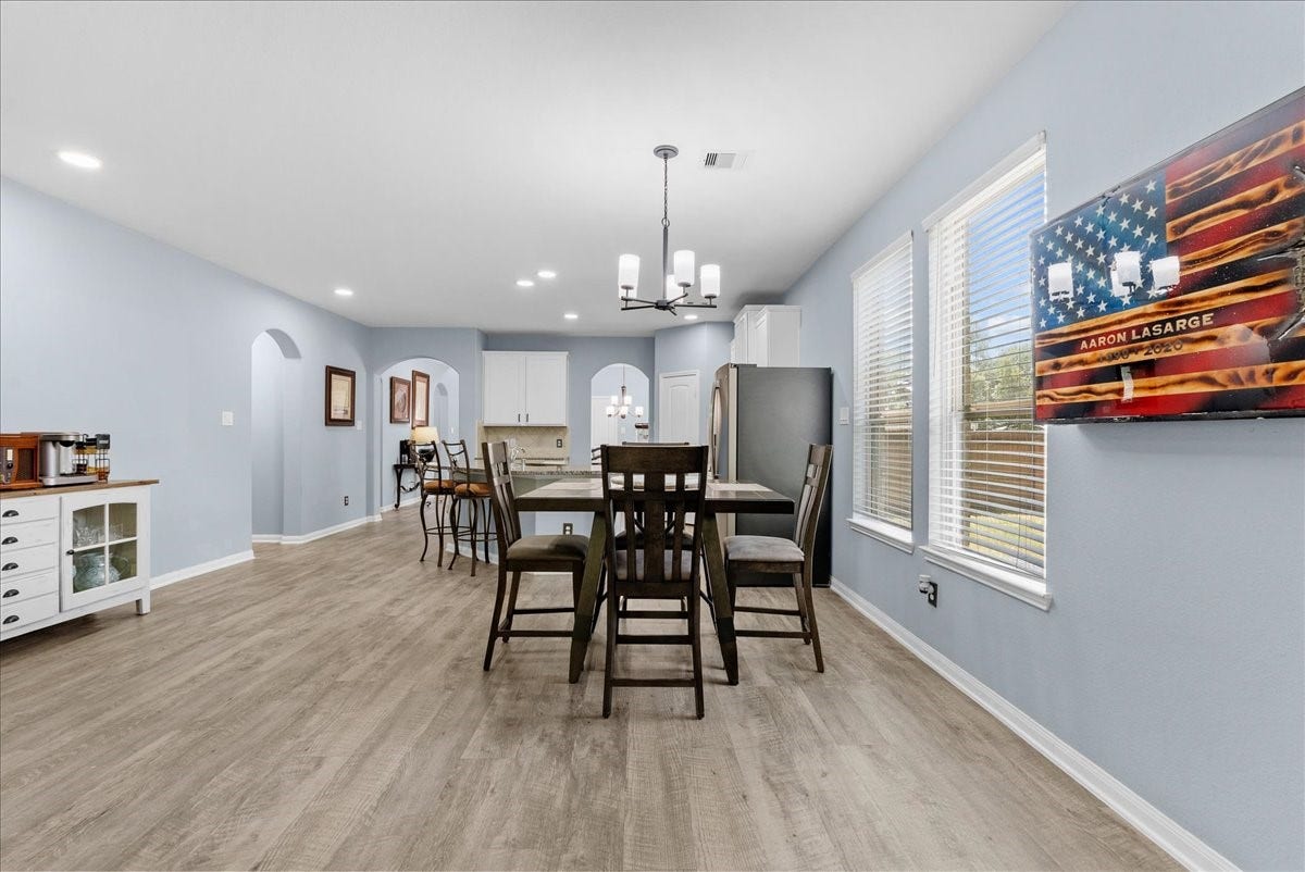 28619 Riverside Crest Lane, Huffman, TX 77336 Seamless flow between the kitchen and dining spaces makes gathering with family and friends easy.