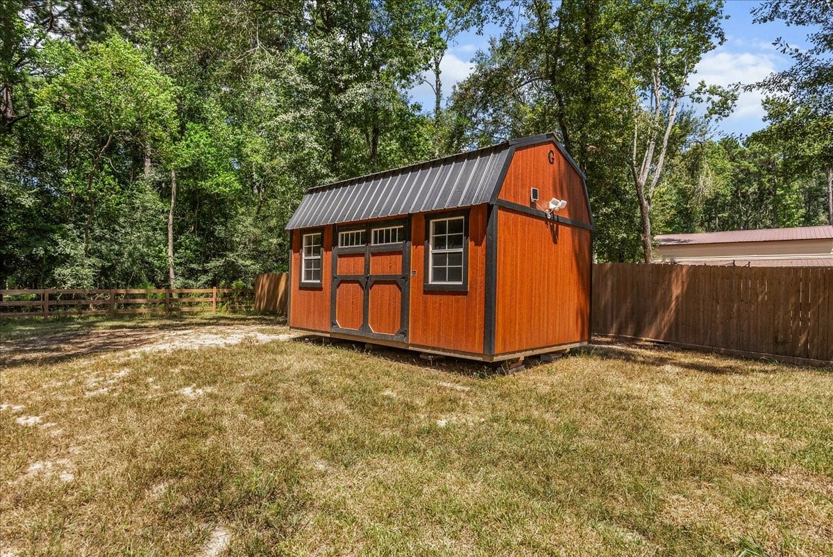 28619 Riverside Crest Lane, Huffman, TX 77336 Large storage shed provides convenient space for lawn equipment, tools, outdoor toys and more.
