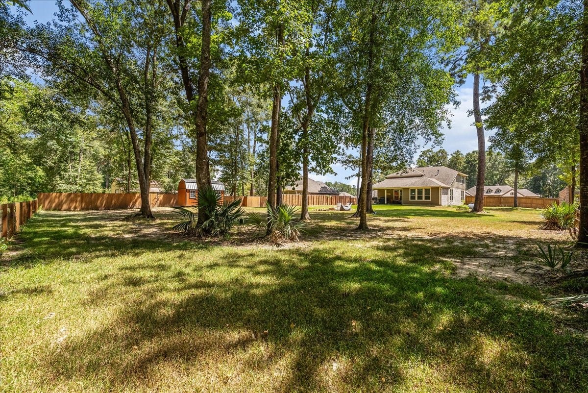 28619 Riverside Crest Lane, Huffman, TX 77336 Mature trees create a peaceful backyard setting with plenty of shade, privacy and room to enjoy the outdoors.