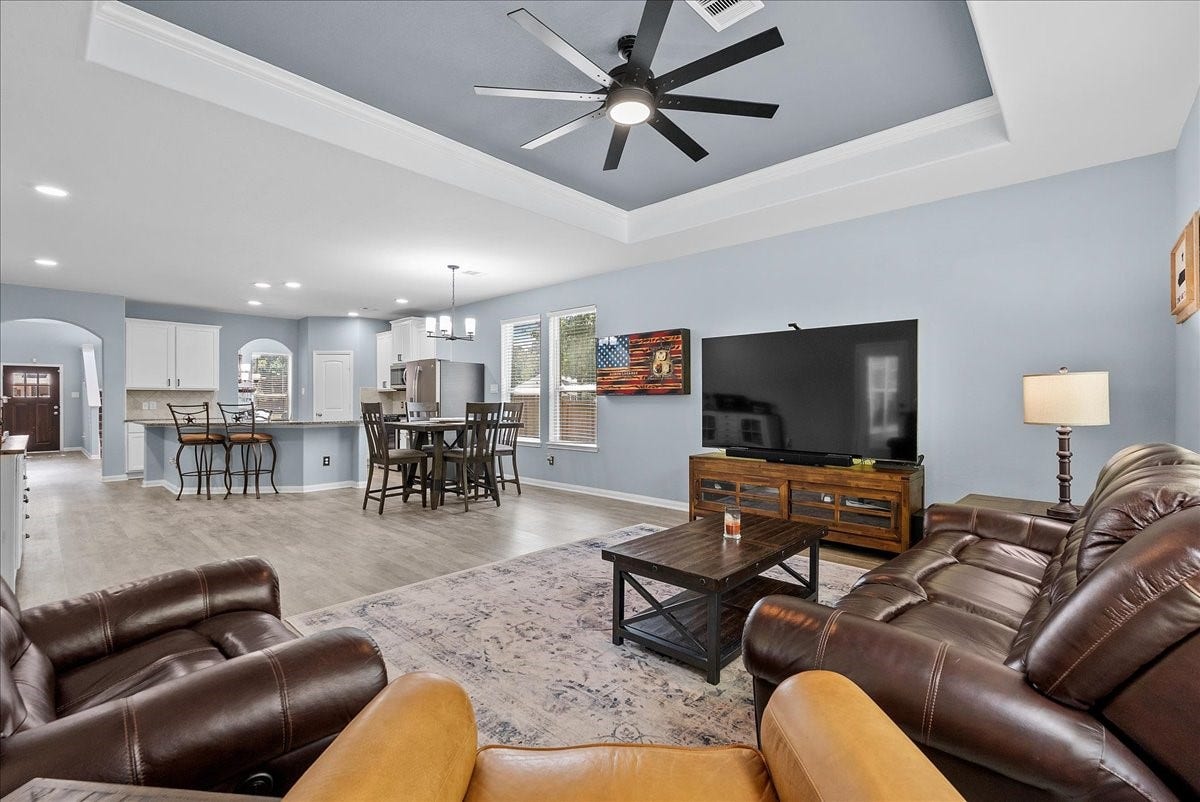 28619 Riverside Crest Lane, Huffman, TX 77336 Another view of the open living space showcases the beautiful tray ceiling and easy flow into the kitchen and dining areas.