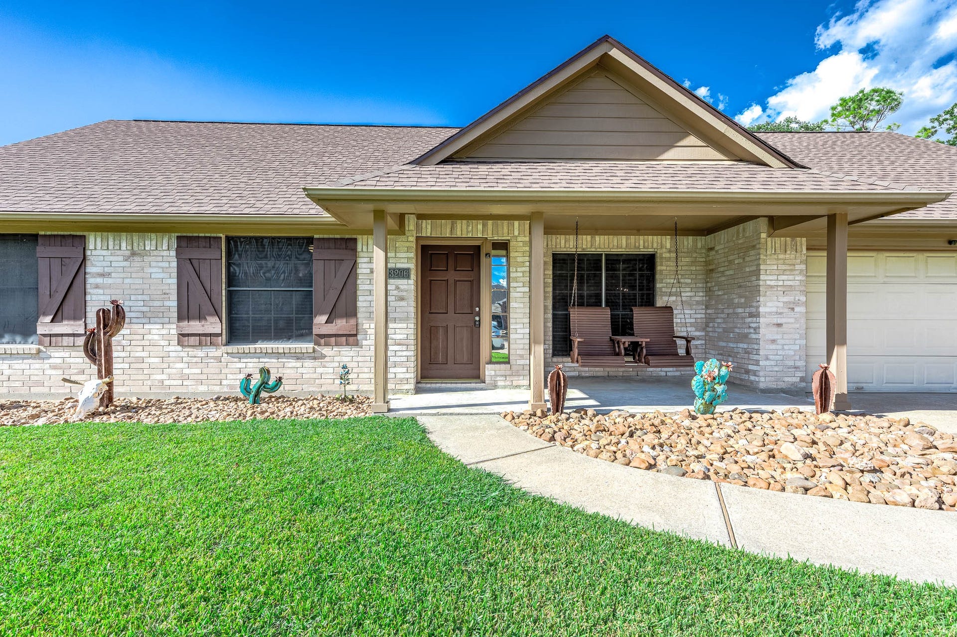 Custom shutters and landscape using stones provide a clean well maintained look!