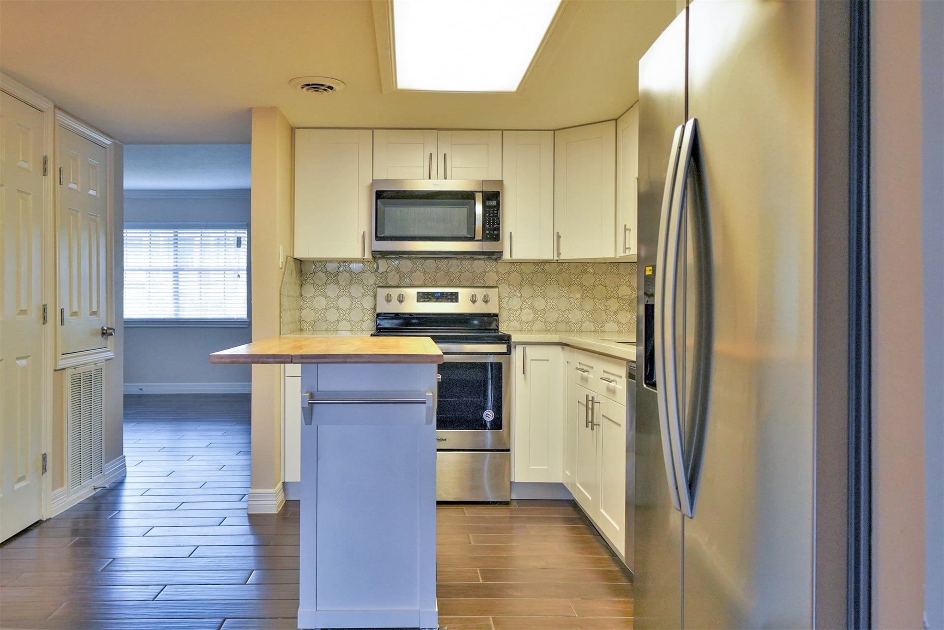 12633 Memorial Drive, #77, Houston, TX 77024 Kitchen opens to both living & den rooms... island on wheels