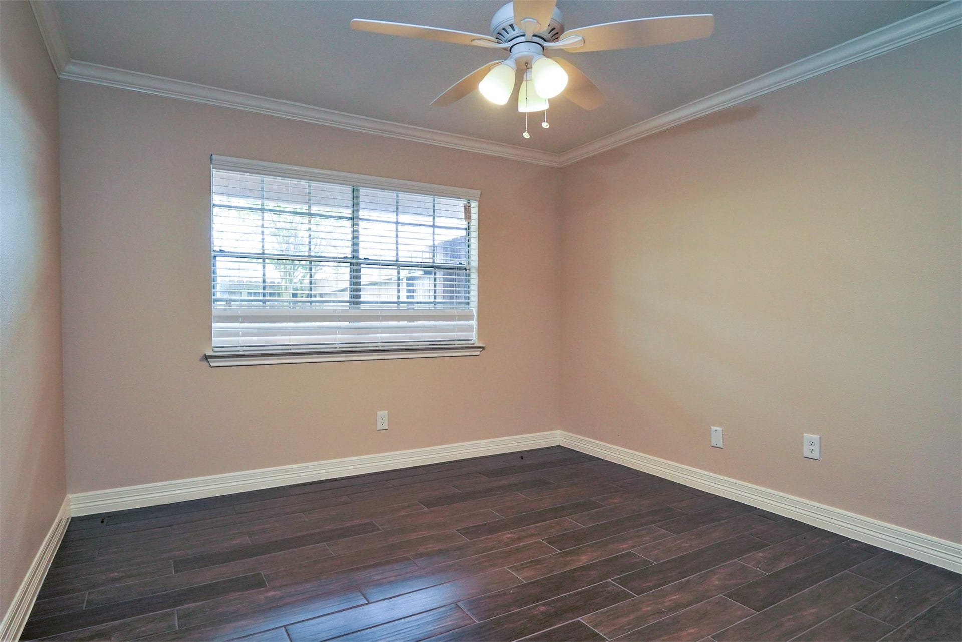 12633 Memorial Drive, #77, Houston, TX 77024 Primary bedroom with tile "like hardwood floors, ceiling fan, crown molding, window overlooks back patio