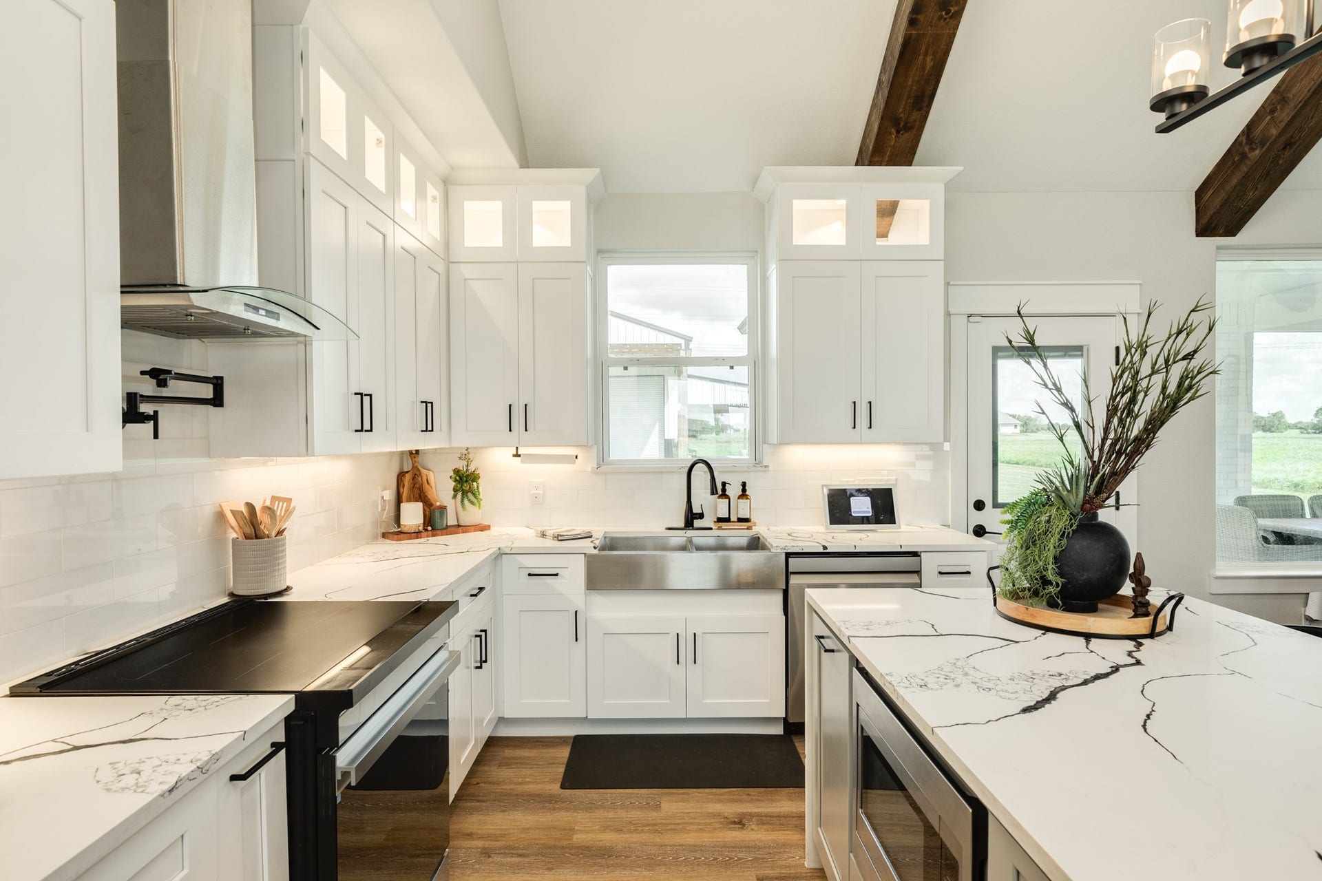 608 Angus Trail, Angleton, TX 77515 Smooth top electric cooktop, stainless steel undermount farmhouse sink and a window perfectly placed window over the sink