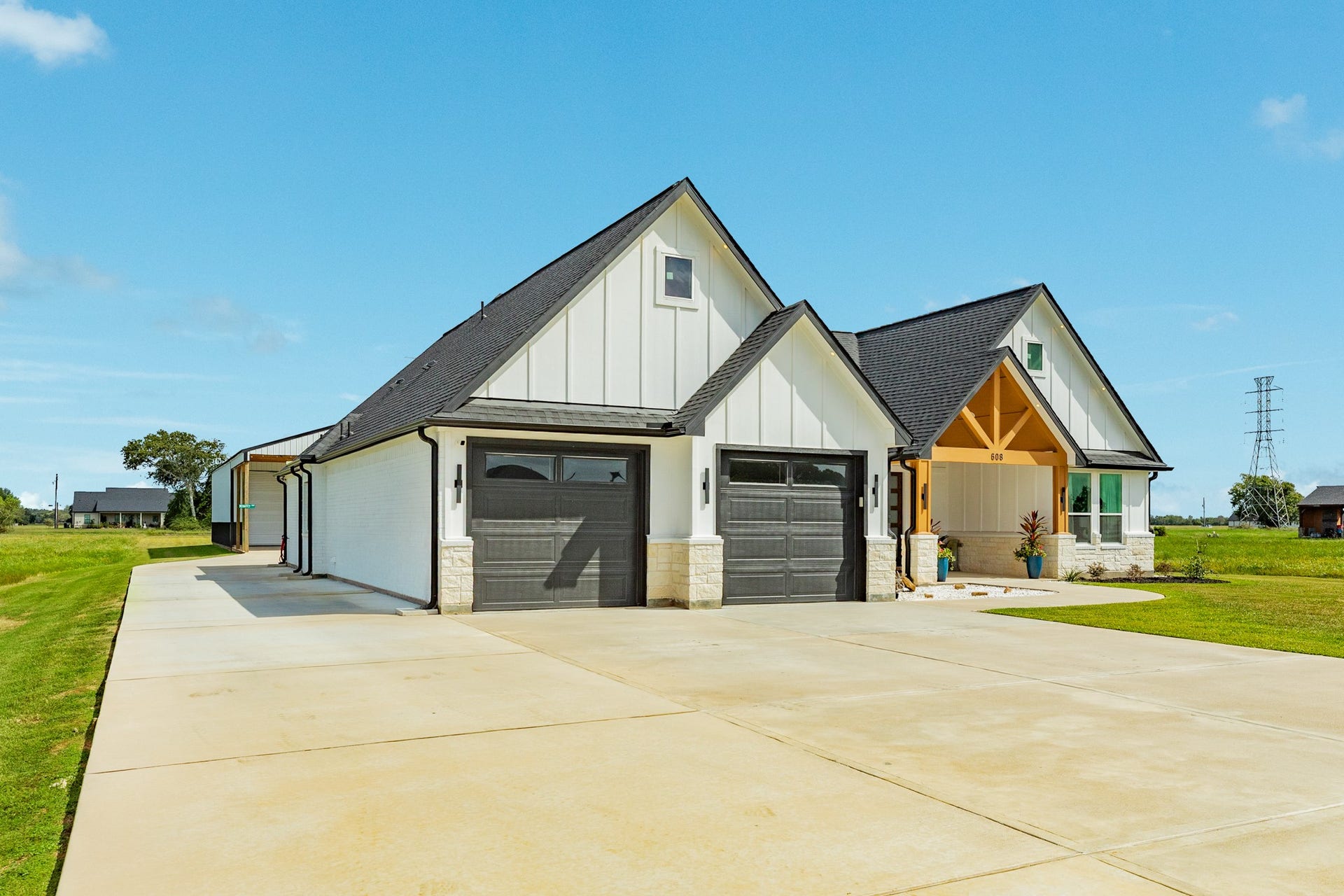 608 Angus Trail, Angleton, TX 77515 Driveway extended beyond the house to access the workshop