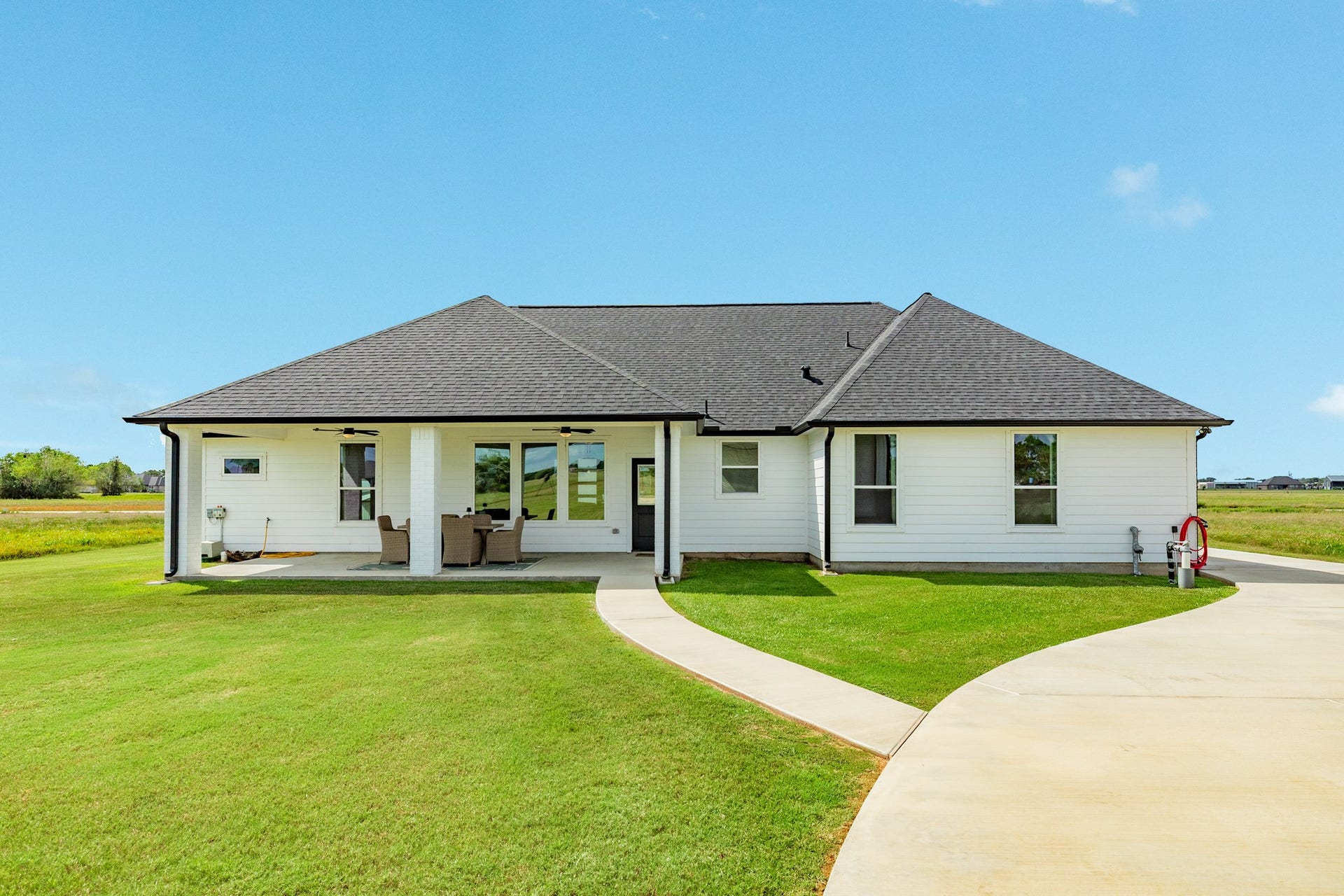 608 Angus Trail, Angleton, TX 77515 Back of home with walkway access to the workshop. Additional driveway added for access to the shop from the driveway