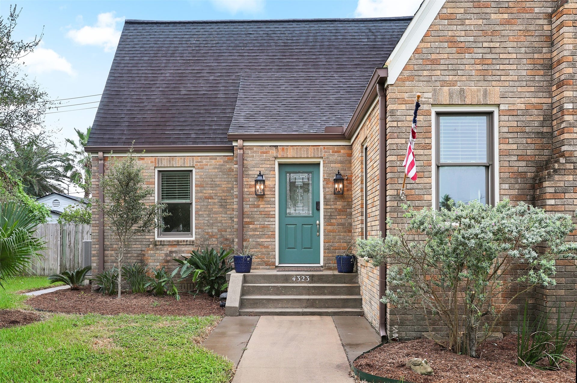 4323 Sherman Boulevard, Galveston, TX 77550 Welcoming green front door, flanked by classic lantern-style lights.