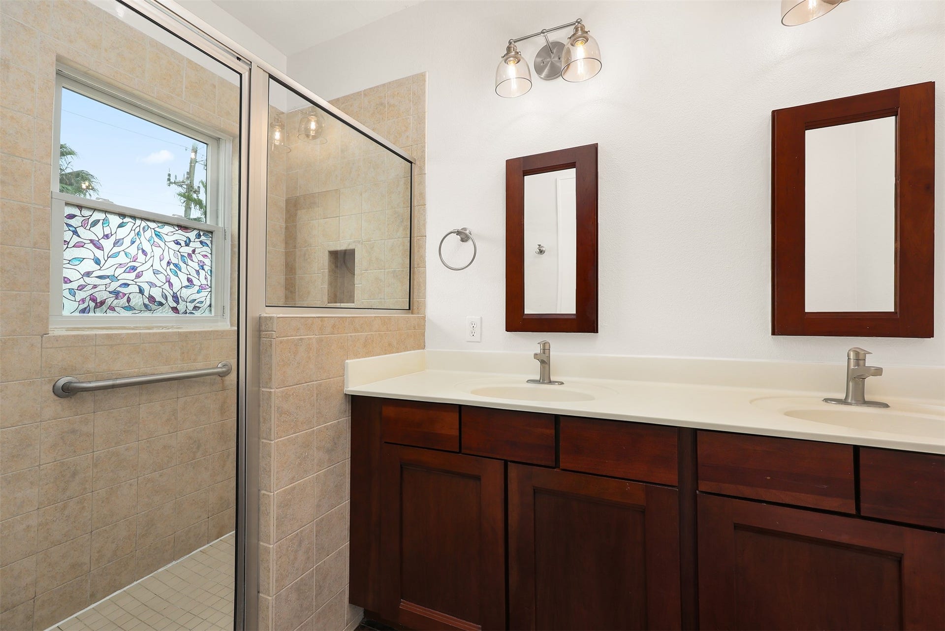 4323 Sherman Boulevard, Galveston, TX 77550 Ensuite bathroom featuring a dual-sink vanity with spacious glass-enclosed shower.