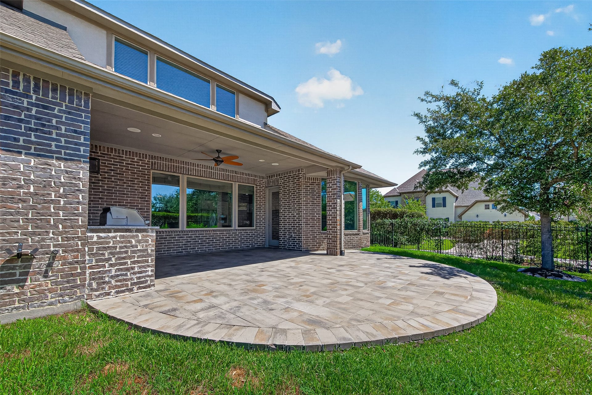 30 Argosy Bend Place, Tomball, TX 77375 Beautiful covered back patio with ceiling fan and outdoor kitchen.