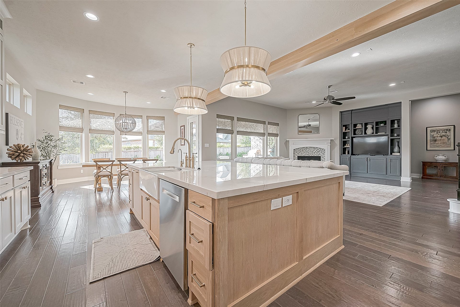 30 Argosy Bend Place, Tomball, TX 77375 Stunning custom pendants hang elegantly over the quartzite island, adding a touch of sophistication to the space.