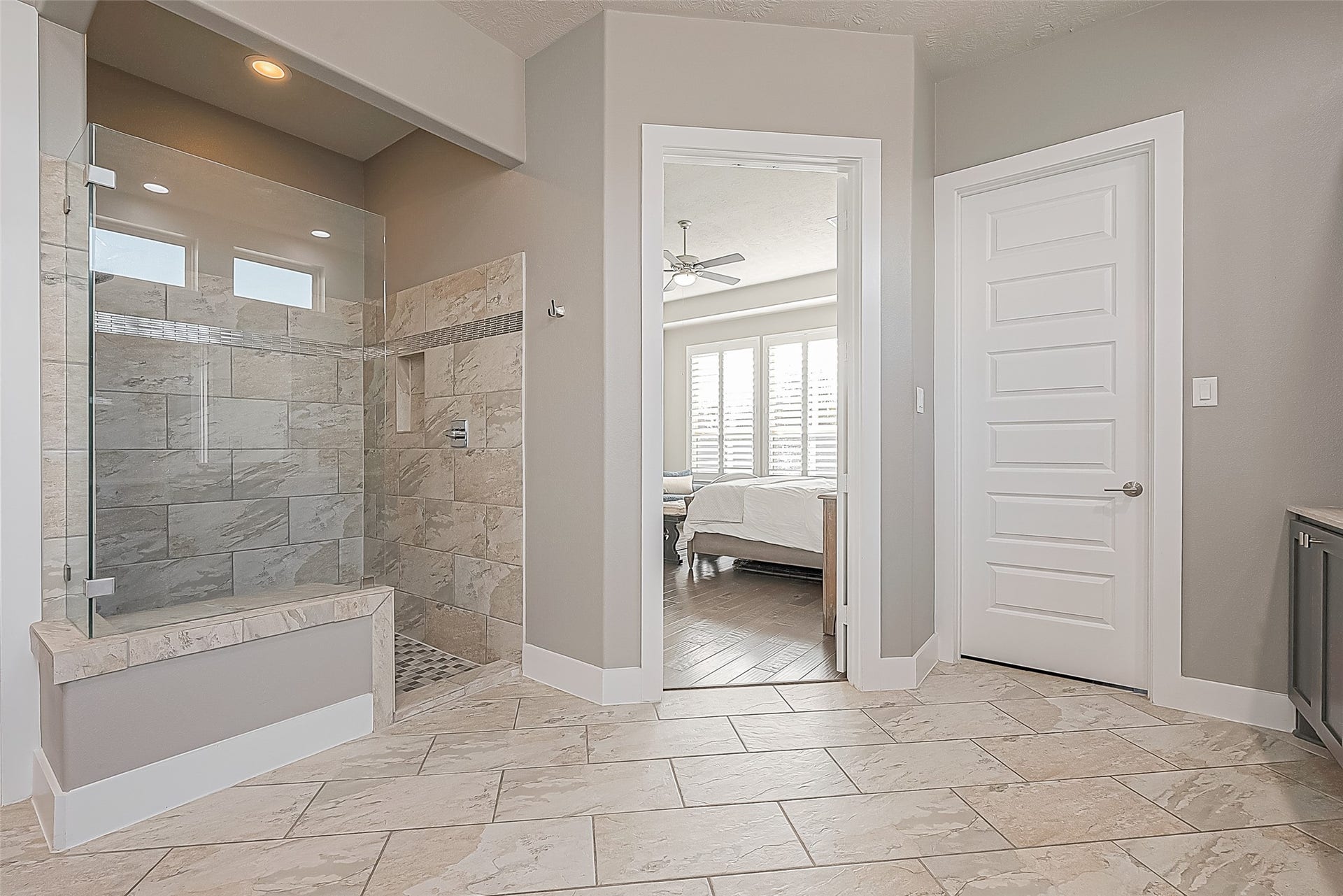 30 Argosy Bend Place, Tomball, TX 77375 The stunning primary shower has decorative tiles and a frameless shower door.
