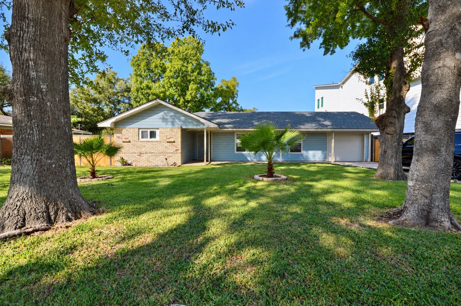 1837 Wycliffe Drive, Houston, TX 77043 Charming single-story home with a spacious front yard, mature trees, and a cozy brick and siding exterior.