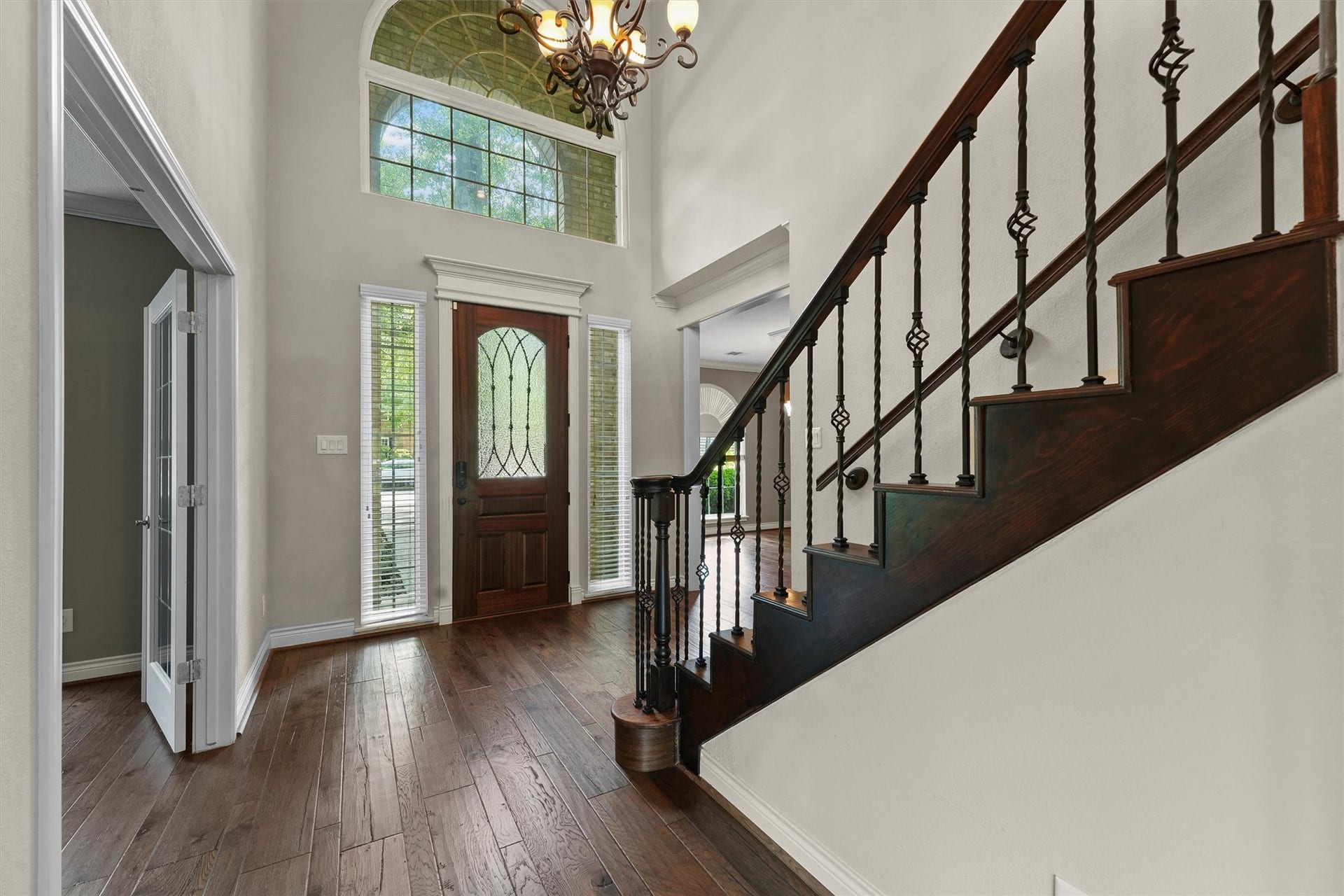 2023 Forest Garden Drive, Kingwood, TX 77345 Two story entry with wood floors and stairs with wrought iron spindles.