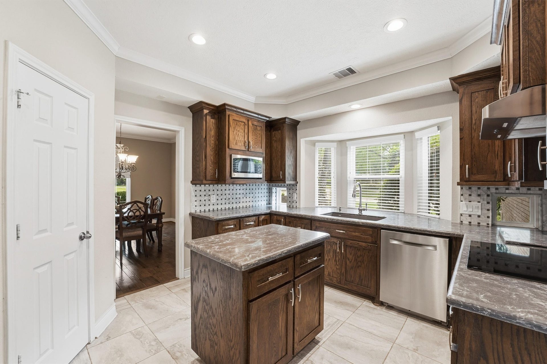 2023 Forest Garden Drive, Kingwood, TX 77345 Lots of light and connected to the dining area for easy meal prep to table!