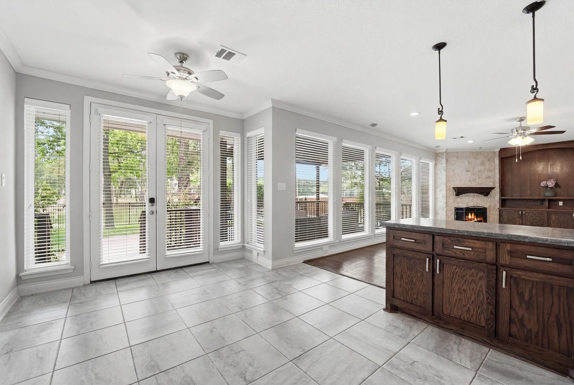 2023 Forest Garden Drive, Kingwood, TX 77345 Breakfast room with access to the outdoor patio and living room. Look at all the windows.