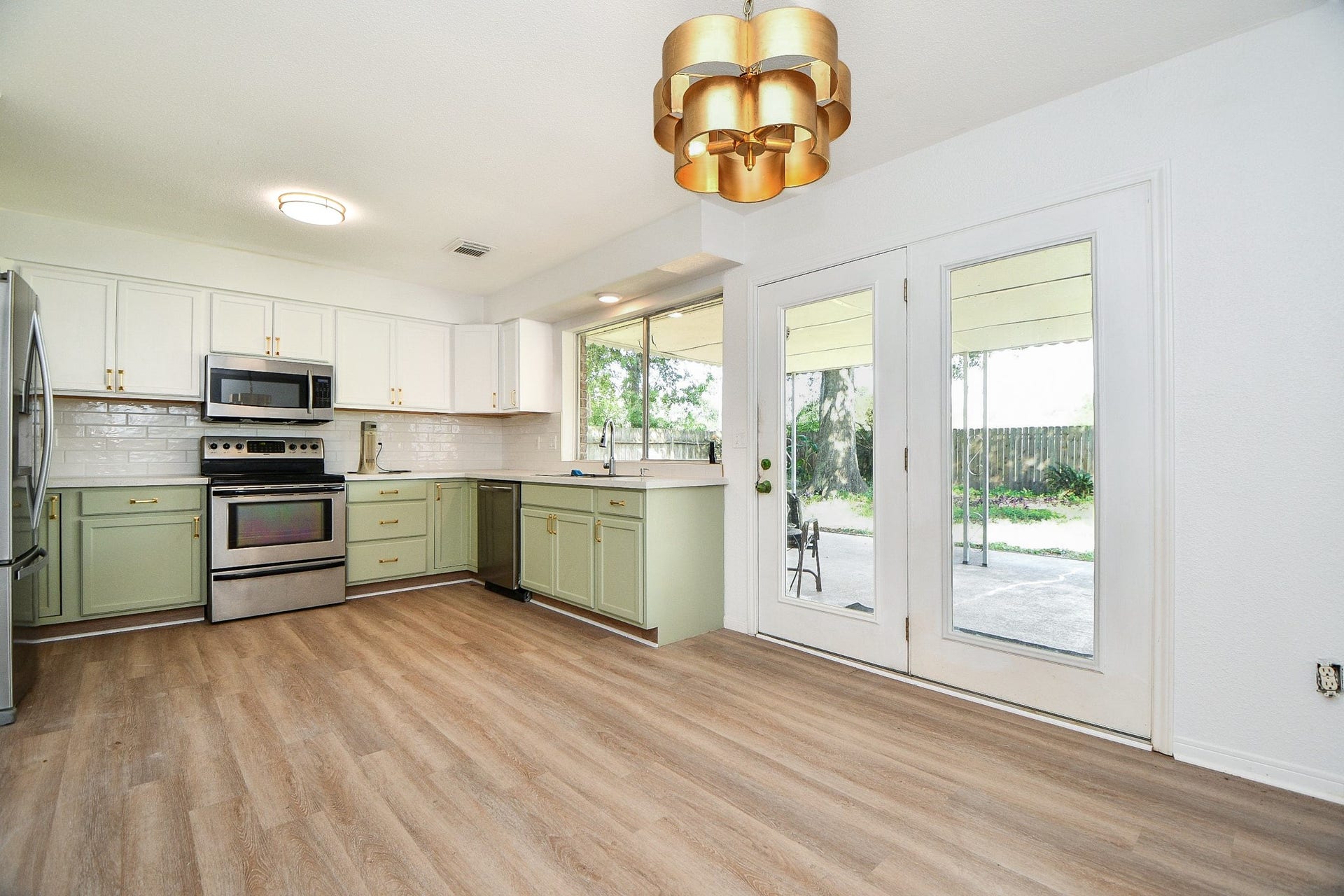 22514 Red River Drive, Katy, TX 77450 Kitchen has new cabinets, quartz counters, light fixture, paint and hardware.