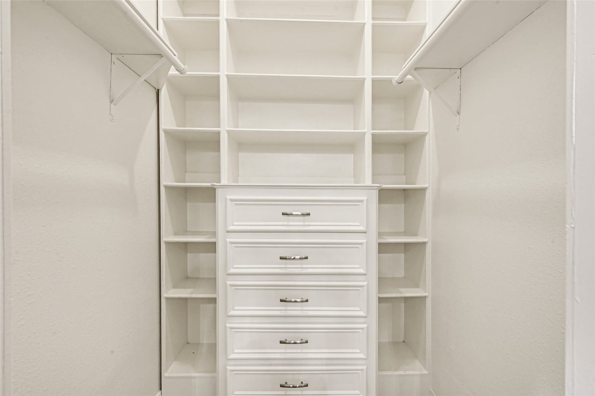 19763 Irenell Dr, Porter, TX 77365 Spacious walk-in closet featuring built-in shelving and drawers for optimal organization.