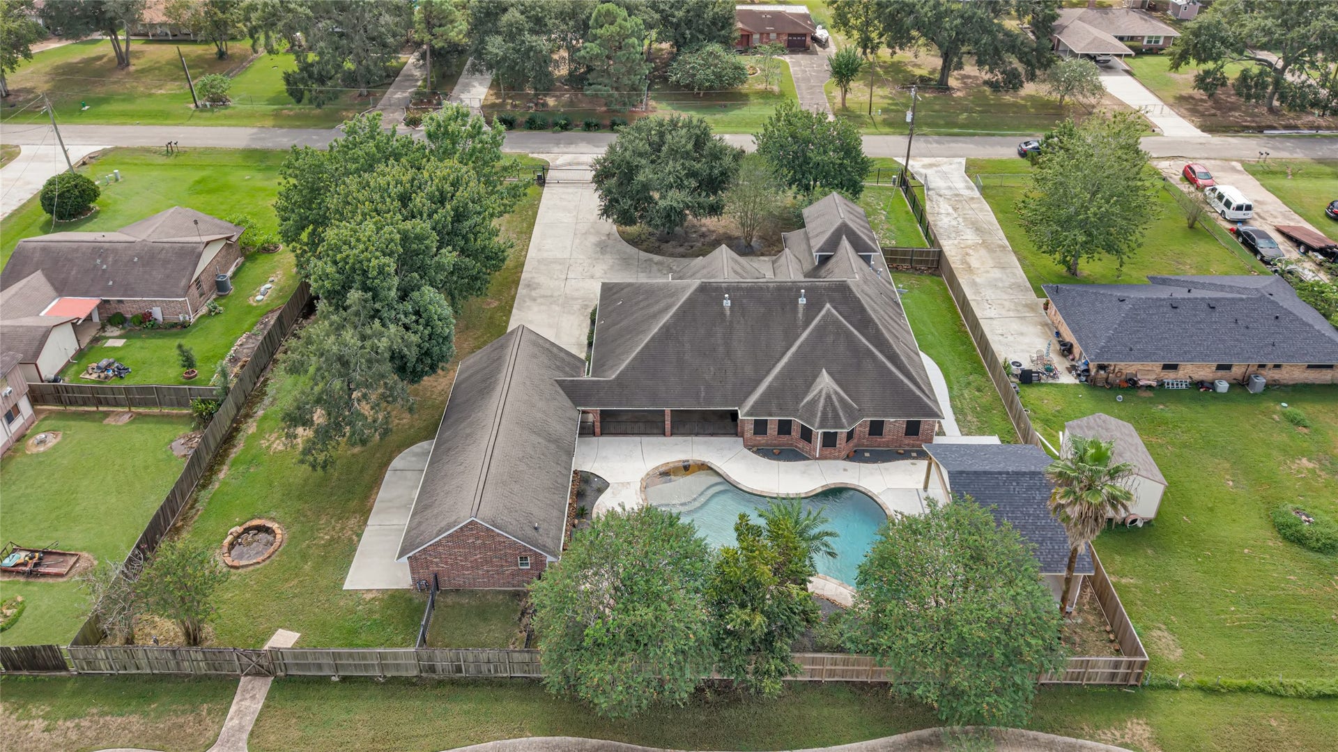 19763 Irenell Dr, Porter, TX 77365 Expansive property featuring a spacious home with a stunning backyard oasis, complete with a large pool and ample patio space, perfect for entertaining or relaxing.