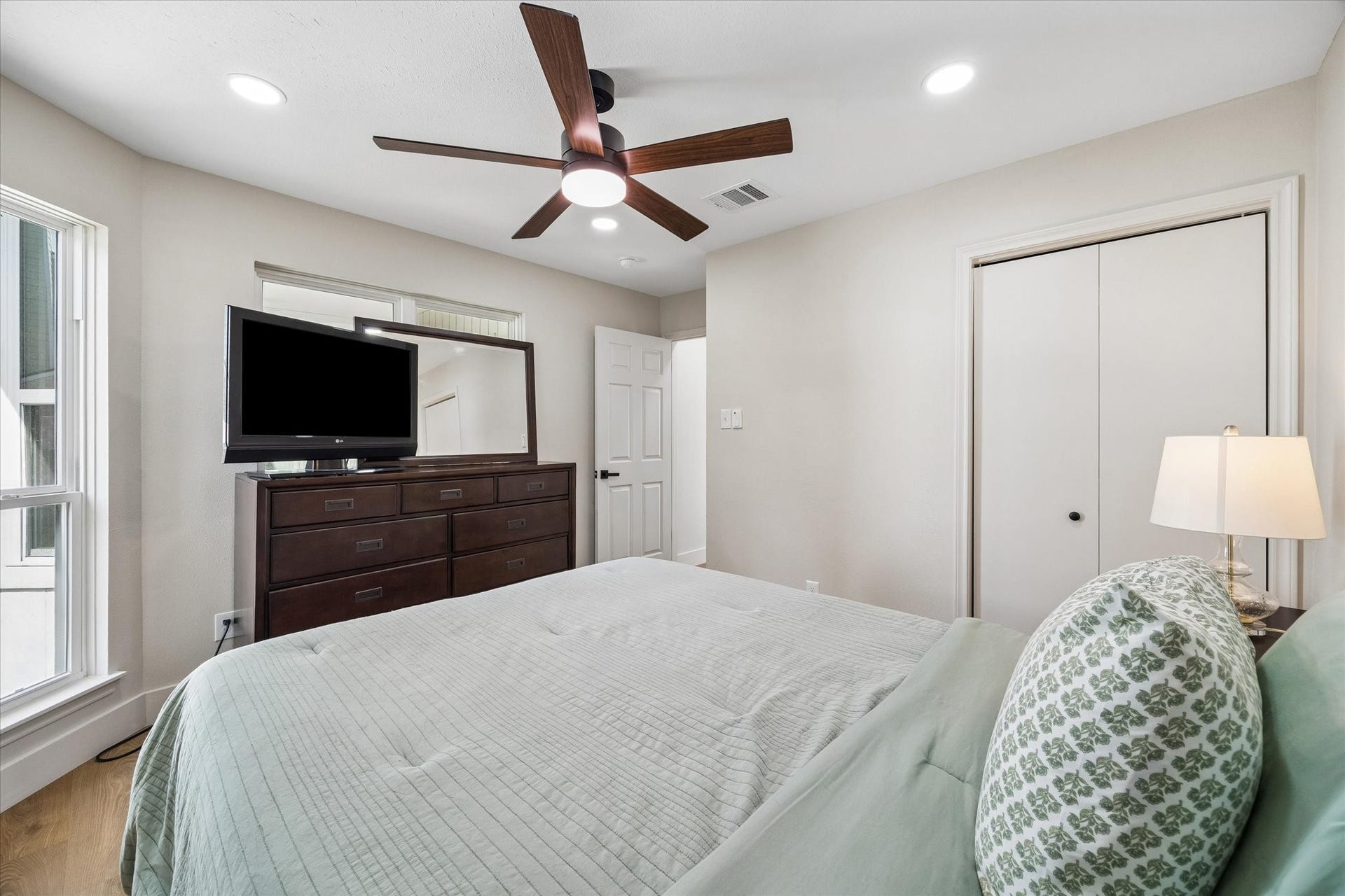 2302 Ashford Hollow Lane, Houston, TX 77077 Elegant secondary bedroom featuring a spacious layout with a large window for natural light, modern ceiling fan, and ample storage.
