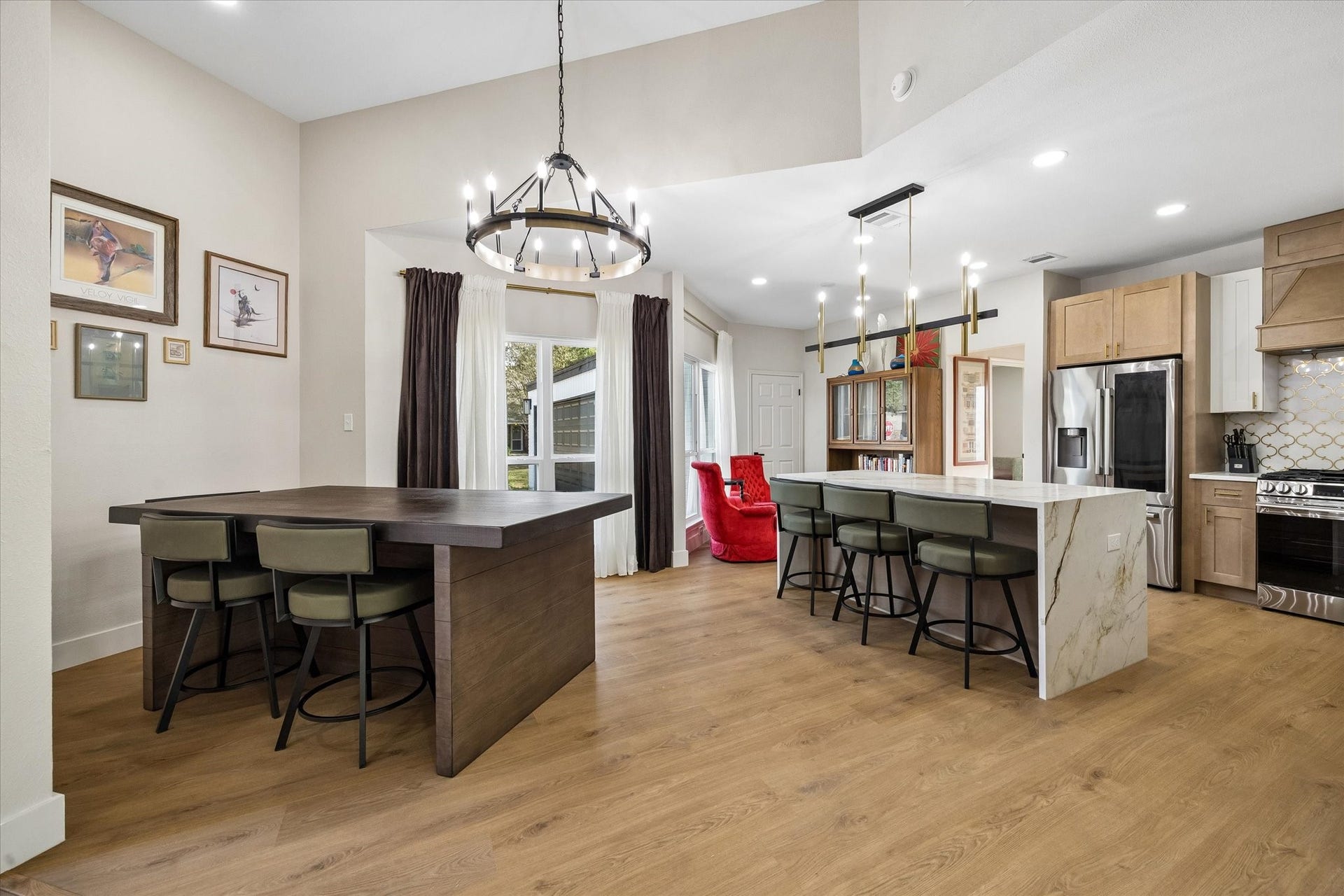 2302 Ashford Hollow Lane, Houston, TX 77077 Spacious open-concept kitchen and dining area features a large island with elegant light fixtures, and a cozy dining nook with a view.