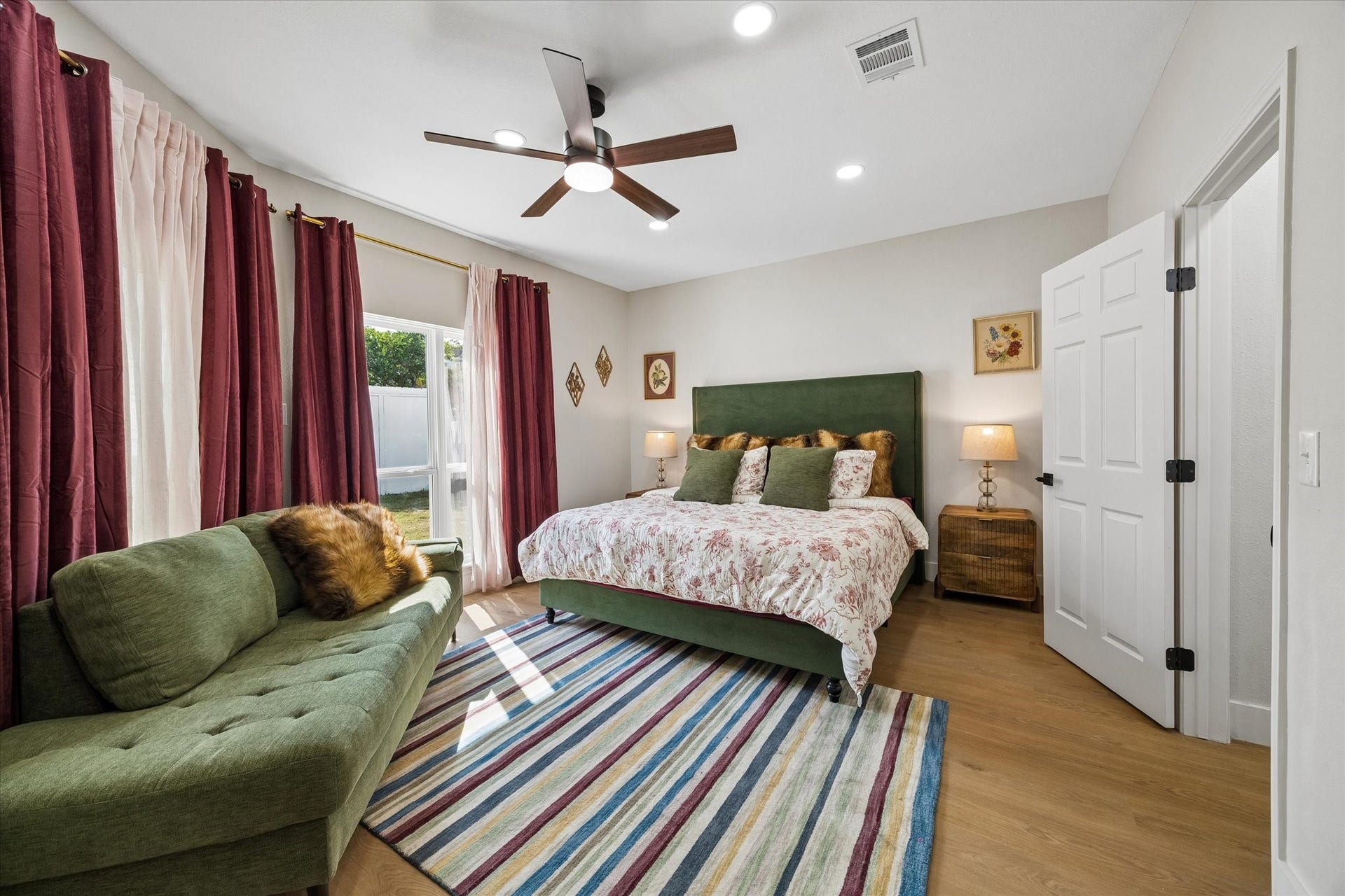 2302 Ashford Hollow Lane, Houston, TX 77077 The primary bedroom offers a warm, inviting atmosphere with its large windows and en-suite spa like bathroom area.