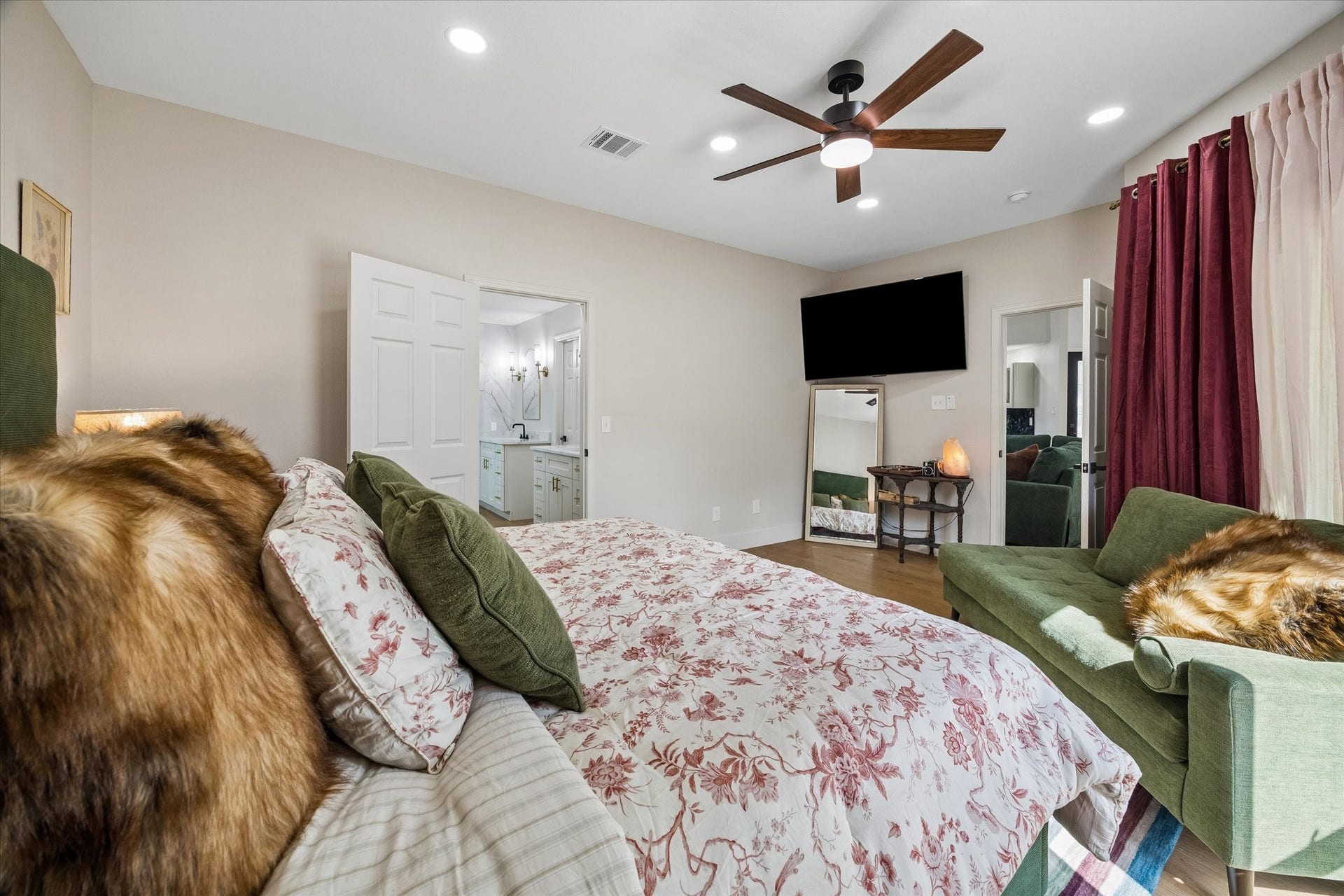 2302 Ashford Hollow Lane, Houston, TX 77077 Another view of the primary bedroom with a stylish ceiling fan and floor to ceiling windows. The room offers direct access to a chic bathroom with modern fixtures.