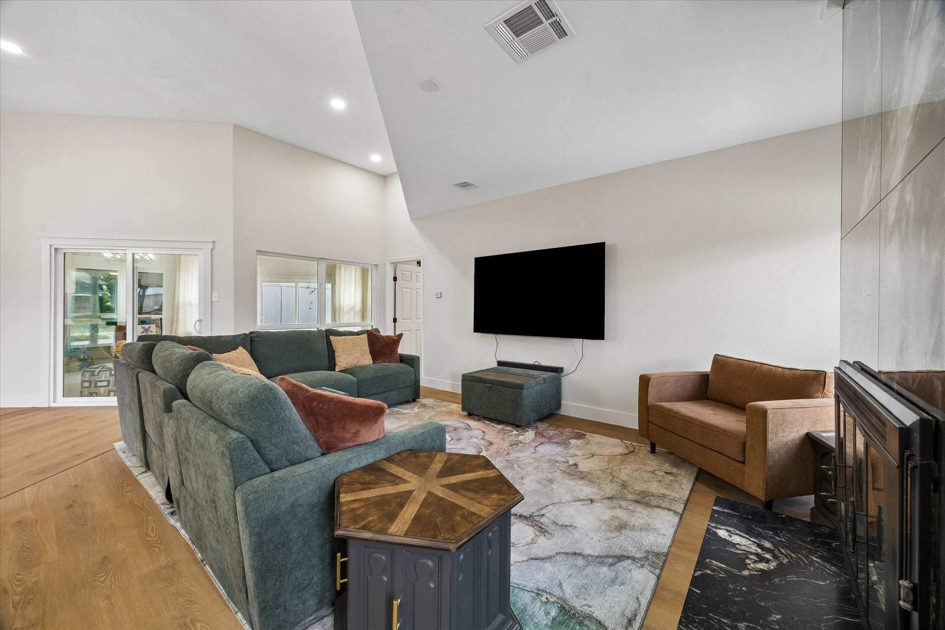 2302 Ashford Hollow Lane, Houston, TX 77077 Spacious living room features high ceilings, a modern fireplace and plenty of natural light.