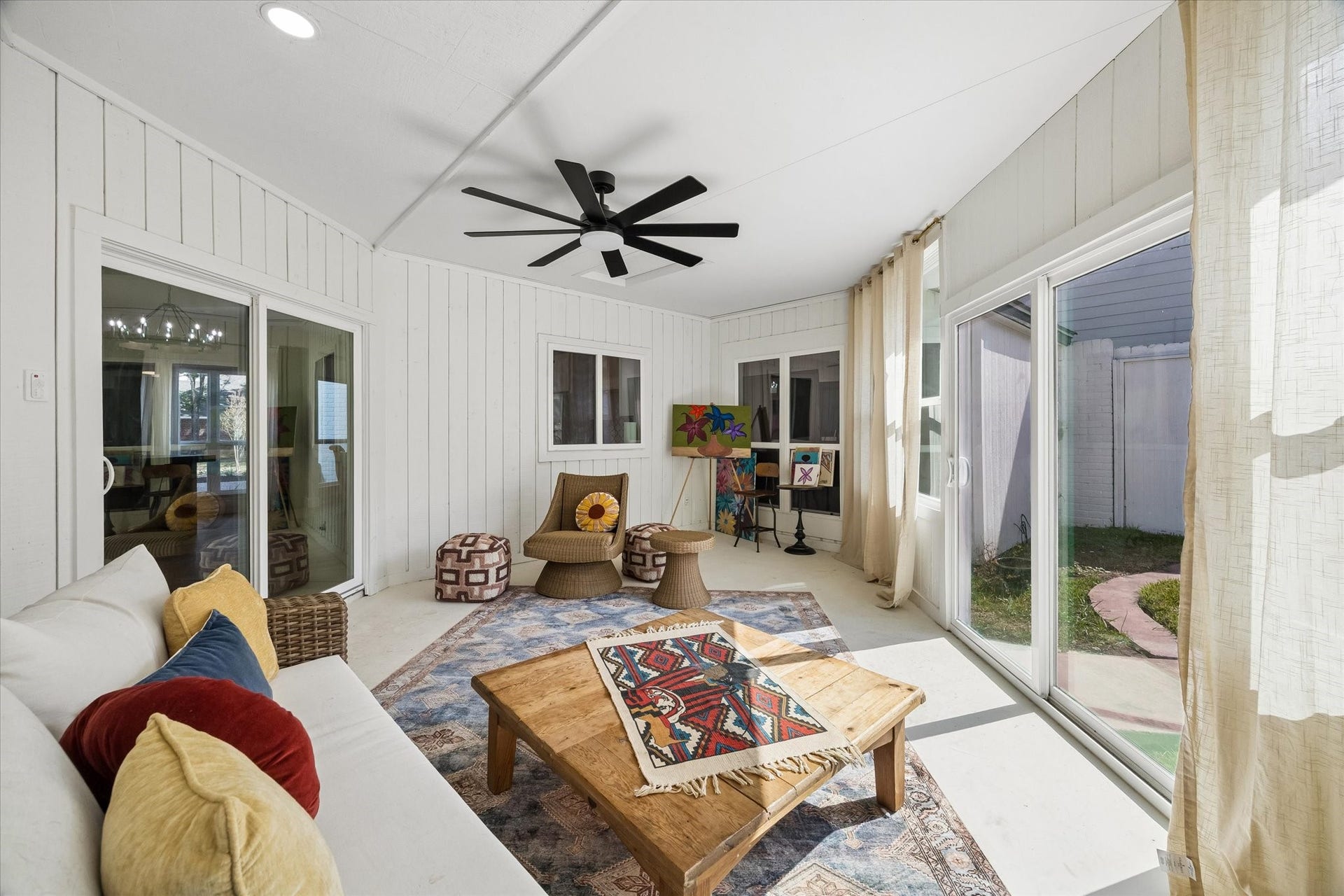 2302 Ashford Hollow Lane, Houston, TX 77077 Bright and inviting sunroom featuring large windows, a modern ceiling fan is the perfect place for rest and relaxation.