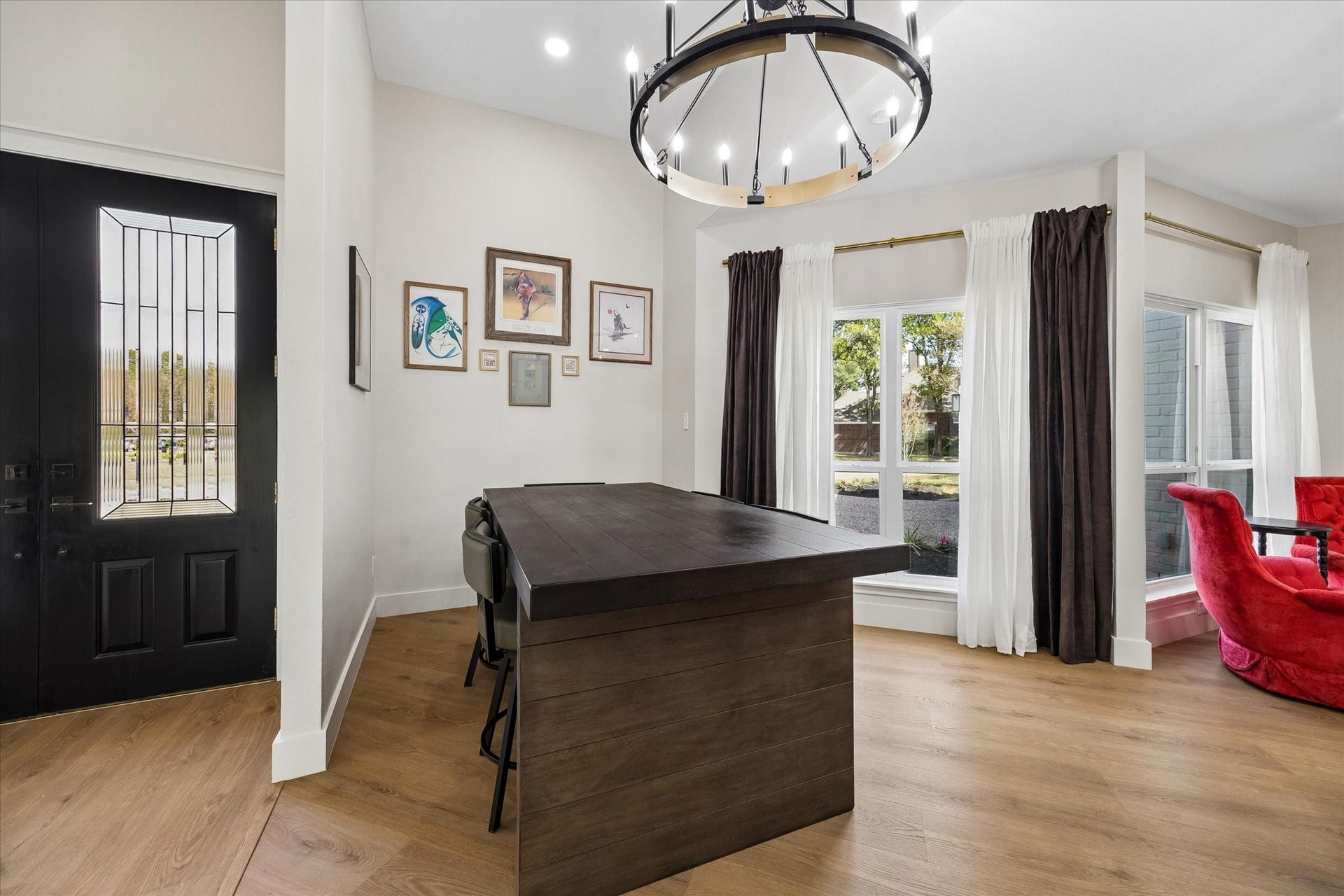 2302 Ashford Hollow Lane, Houston, TX 77077 Elegant dining area featuring a modern chandelier, large windows and conveniently flows into the open kitchen area.