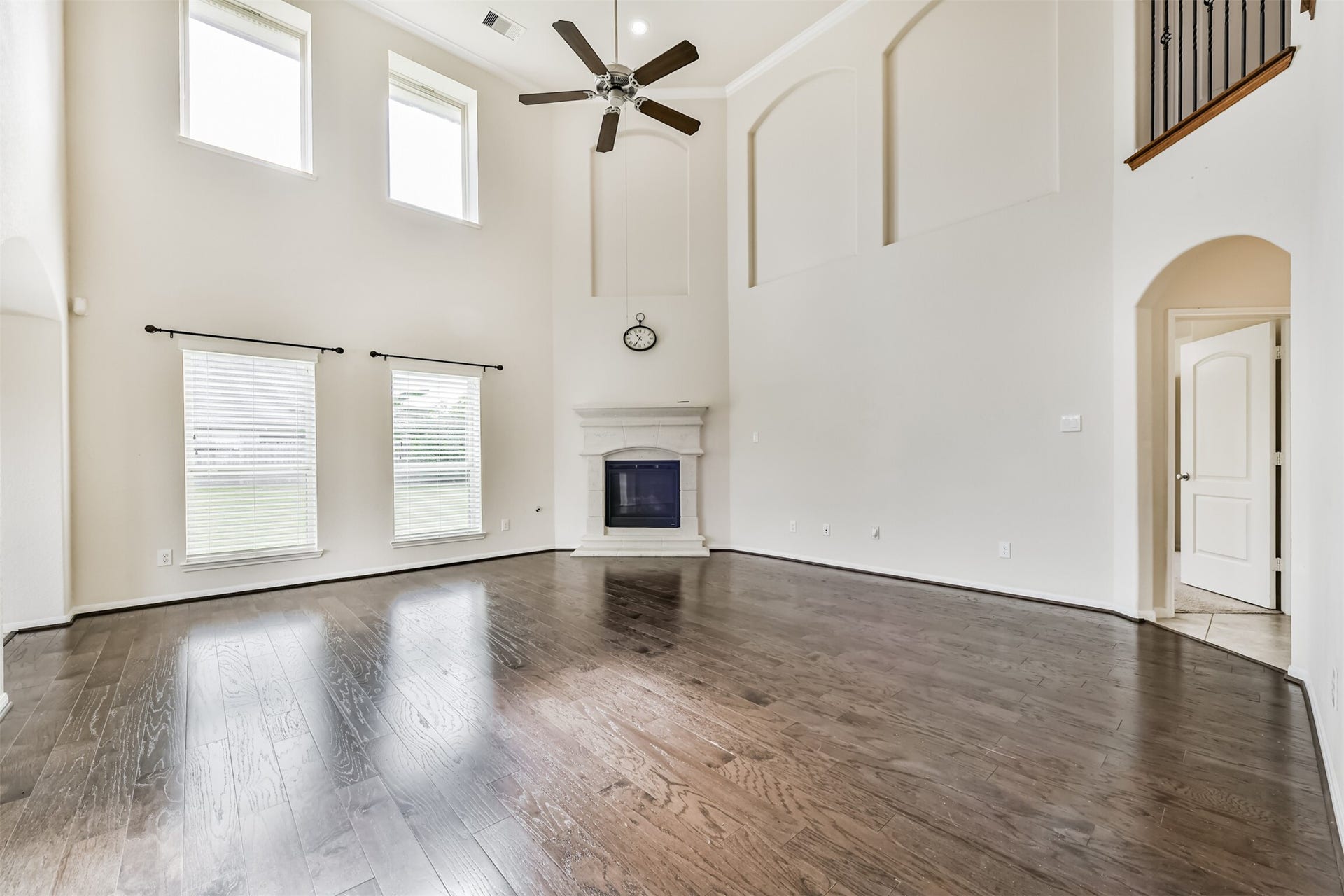 2811 Afton Drive, Pearland, TX 77581 Expansive living area featuring soaring ceilings, abundant natural light, and elegant floors, complete with a cozy fireplace and stylish architectural details.