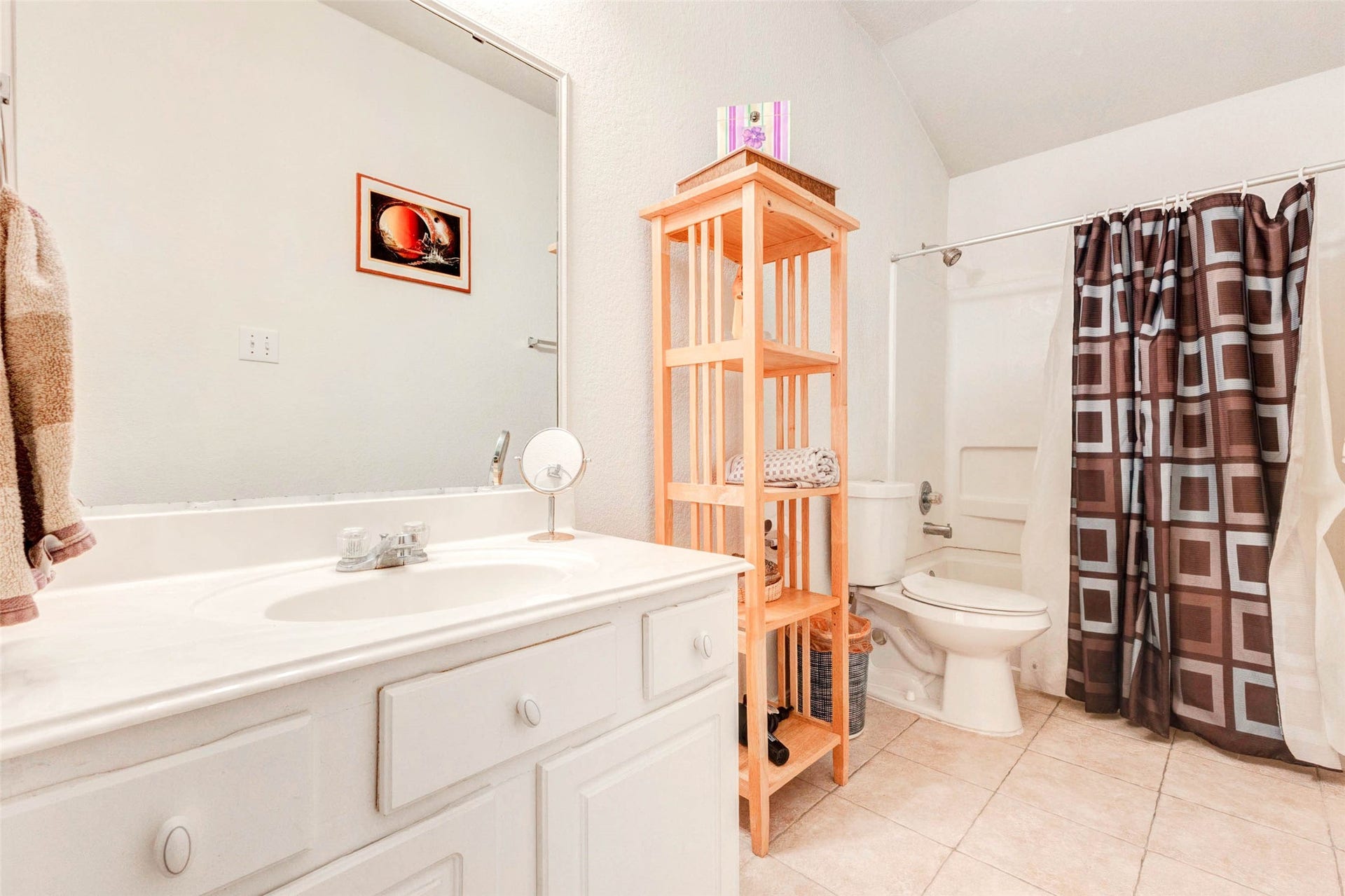 21211 Arcadia Park Lane, Humble, TX 77338 Well-maintained bathroom featuring a single-sink vanity with generous counter space and storage below. A full tub and shower combination offers convenience, while the neutral color palette creates a clean and functional environment. Thoughtful layout and natural light make this bathroom both practical and comfortable for daily use.