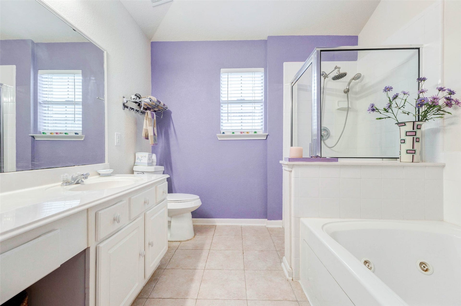 21211 Arcadia Park Lane, Humble, TX 77338 Generously sized primary bathroom with a combination of vanity, jetted tub, and separate shower area. The layout provides flexibility for daily routines, while natural light and soft color tones create a relaxing environment. A comfortable space designed for both convenience and everyday luxury.