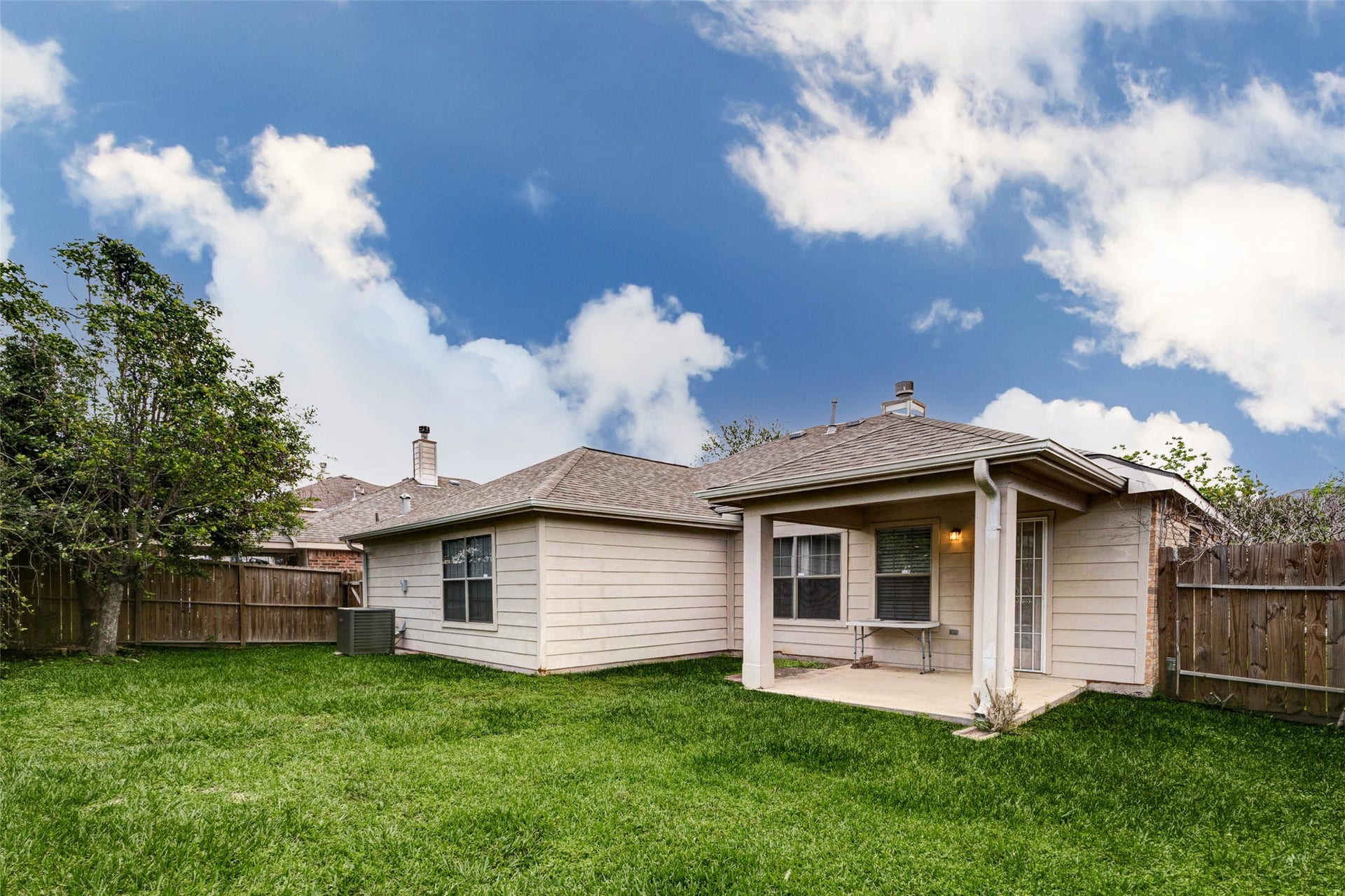 21211 Arcadia Park Lane, Humble, TX 77338 Private backyard retreat featuring a covered patio perfect for outdoor dining or relaxing in the shade. The fully fenced yard offers privacy and plenty of green space for pets, play, or gardening. Durable exterior finishes and a well-maintained lawn create a comfortable outdoor environment ideal for enjoying fresh air and casual gatherings.