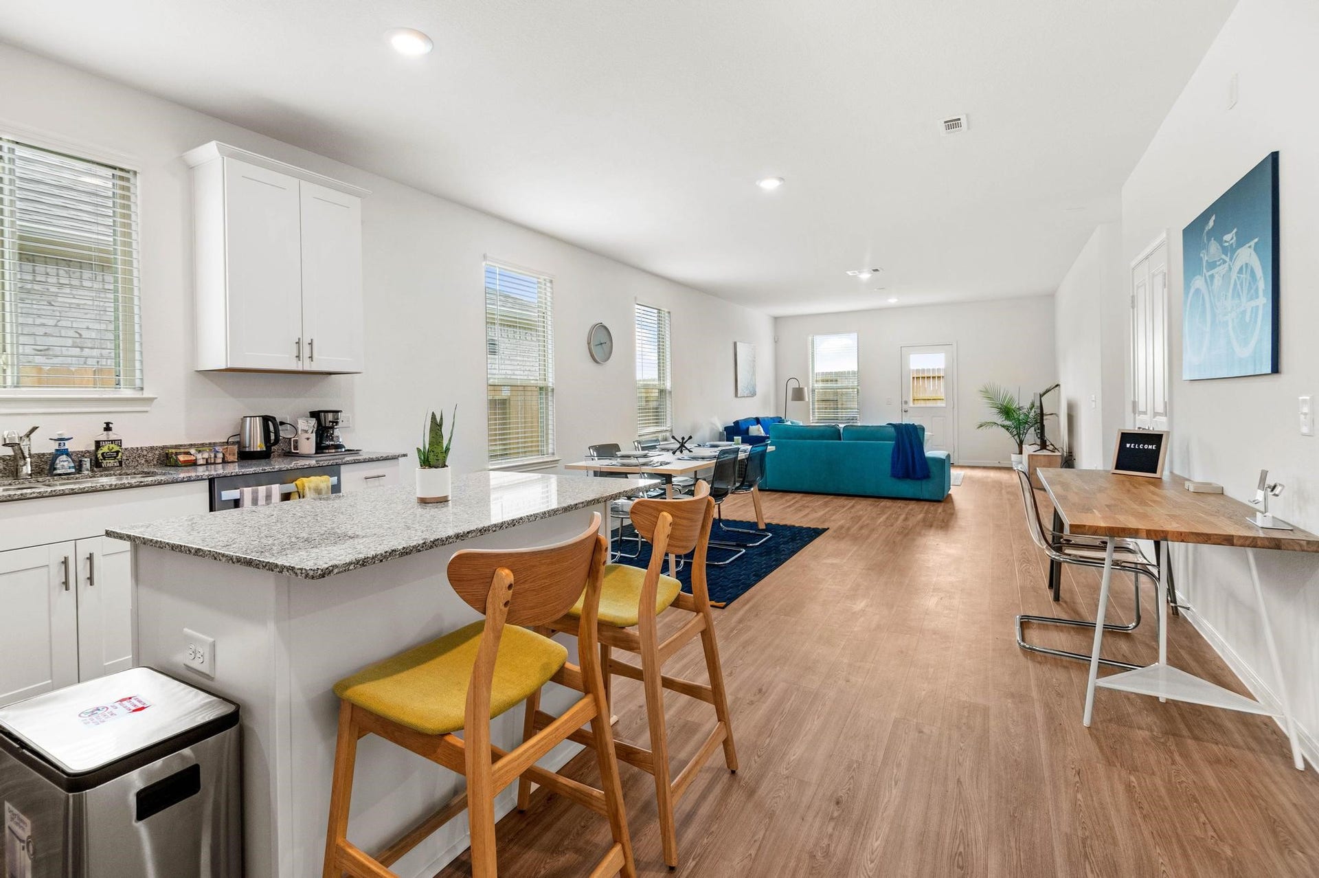 1301 Bright Hill Drive, Katy, TX 77493 Bright and spacious open-concept living area with a modern kitchen featuring granite countertops, a cozy dining space, and a comfortable seating area perfect for relaxation.