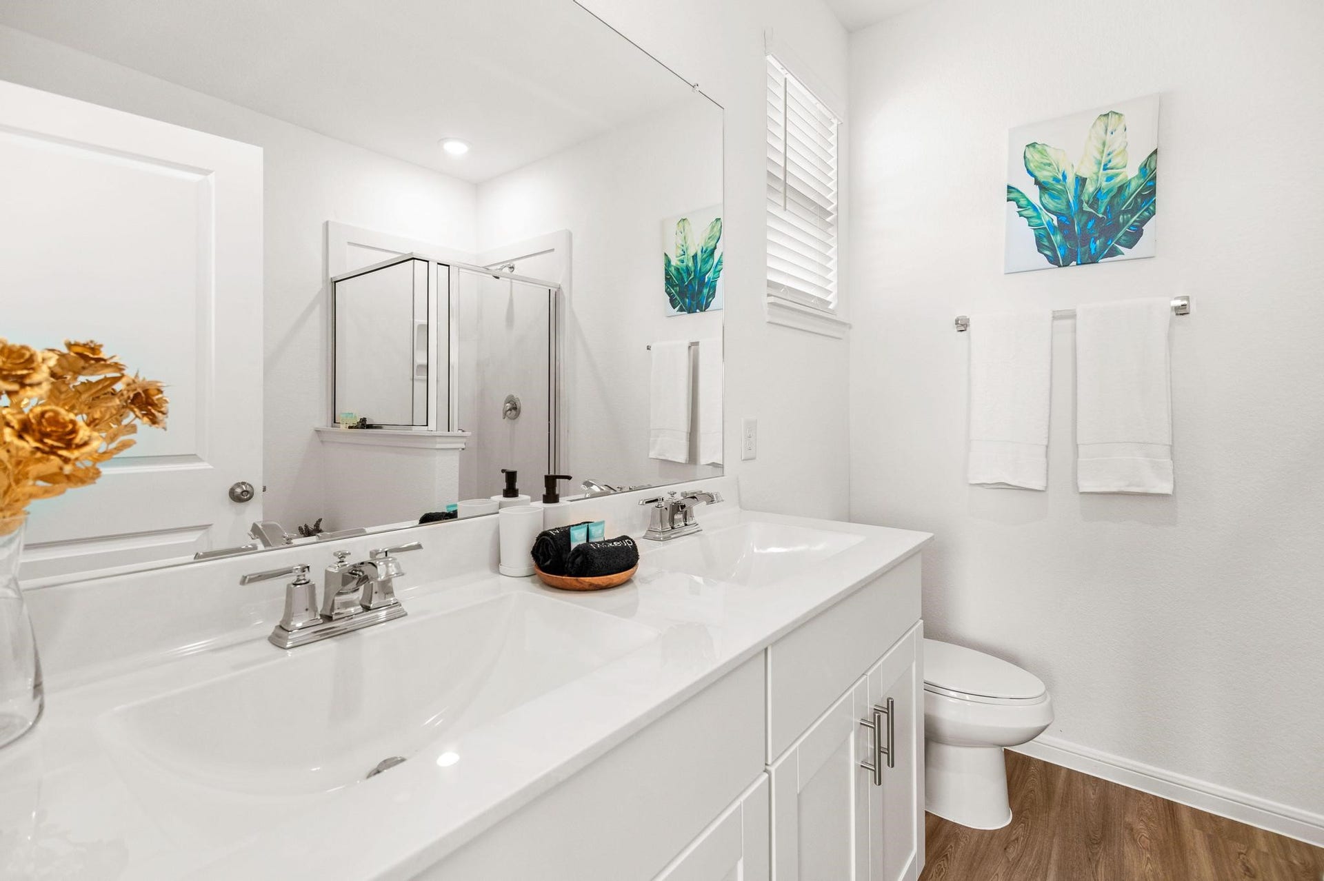 1301 Bright Hill Drive, Katy, TX 77493 Bright and modern bathroom featuring a double vanity with sleek fixtures, a spacious shower, and elegant decor.