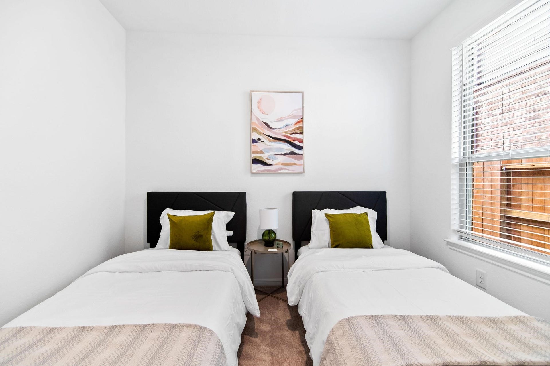 1301 Bright Hill Drive, Katy, TX 77493 Cozy bedroom featuring two twin beds with plush pillows, a stylish nightstand, and abundant natural light from a large window.