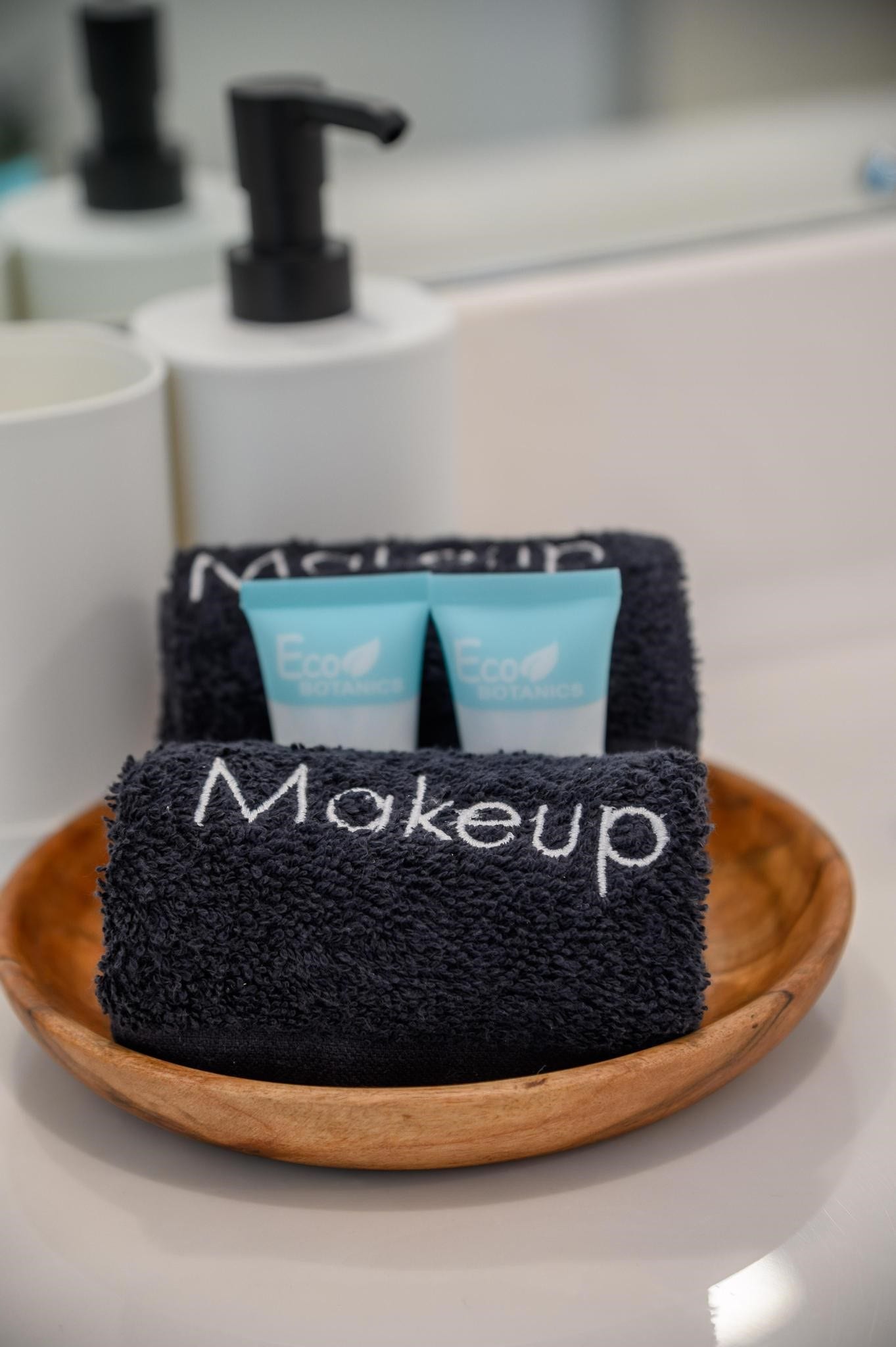 1301 Bright Hill Drive, Katy, TX 77493 Elegant bathroom essentials feature neatly arranged eco-friendly amenities on a stylish wooden tray, creating a touch of luxury and sustainability.