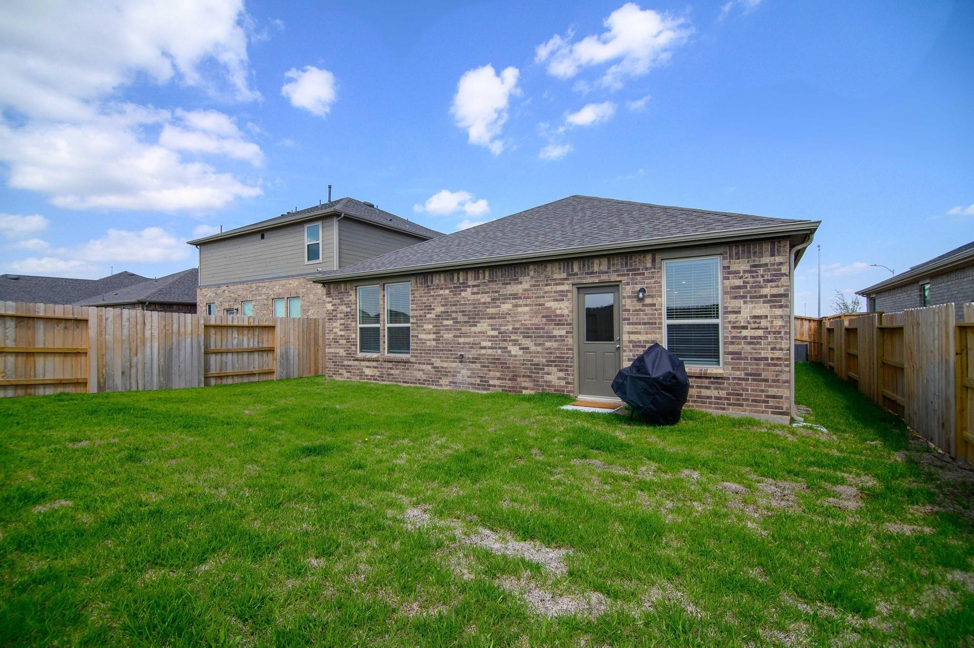 1301 Bright Hill Drive, Katy, TX 77493 Charming brick home with a spacious fenced backyard, perfect for outdoor activities and relaxation.