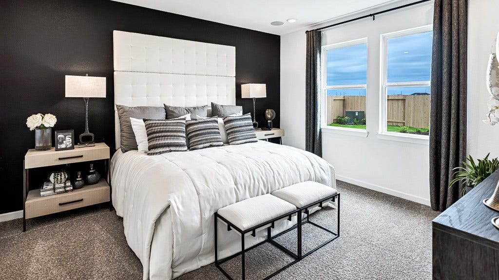 7338 Grand Mason Drive, Cypress, TX 77433 Primary suite has a gorgeous statement wall in black that looks fantastic with the designer white walls. Custom drapery in charcoal color ties room together perfectly.