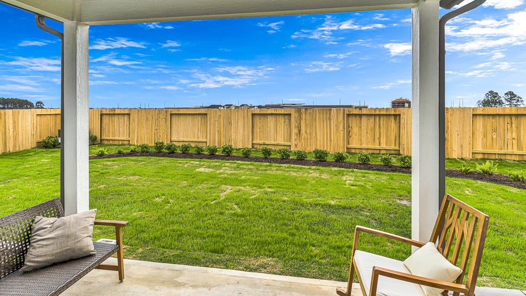 7338 Grand Mason Drive, Cypress, TX 77433 Welcoming backyard has a good neighbor fence with landscaped beds adding color, softness and texture to green lawn.