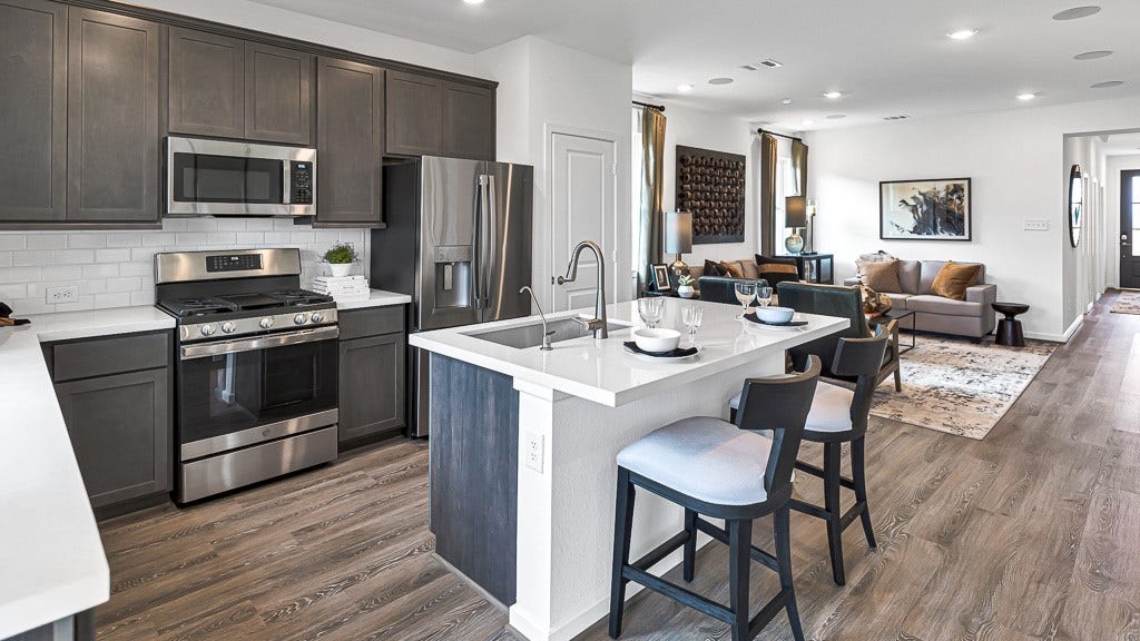 7338 Grand Mason Drive, Cypress, TX 77433 Kitchen island has stainless steel undermount sink, modern faucet including a filtered water faucet and dishwasher.