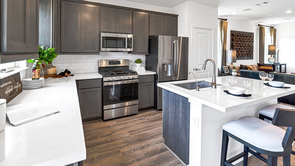 7338 Grand Mason Drive, Cypress, TX 77433 Sleek stainless steel premium appliances are the perfect choice in this kitchen.