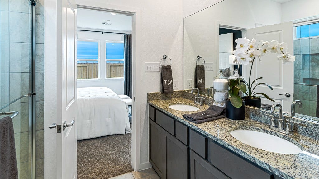 7338 Grand Mason Drive, Cypress, TX 77433 Walk-in shower has recessed shelves for bottles and a glass enclosure.