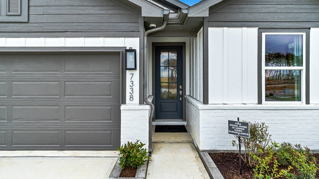 7338 Grand Mason Drive, Cypress, TX 77433 Modern wall lantern highlights the floating address numbers and the gorgeous custom front door for a welcoming entrance.
