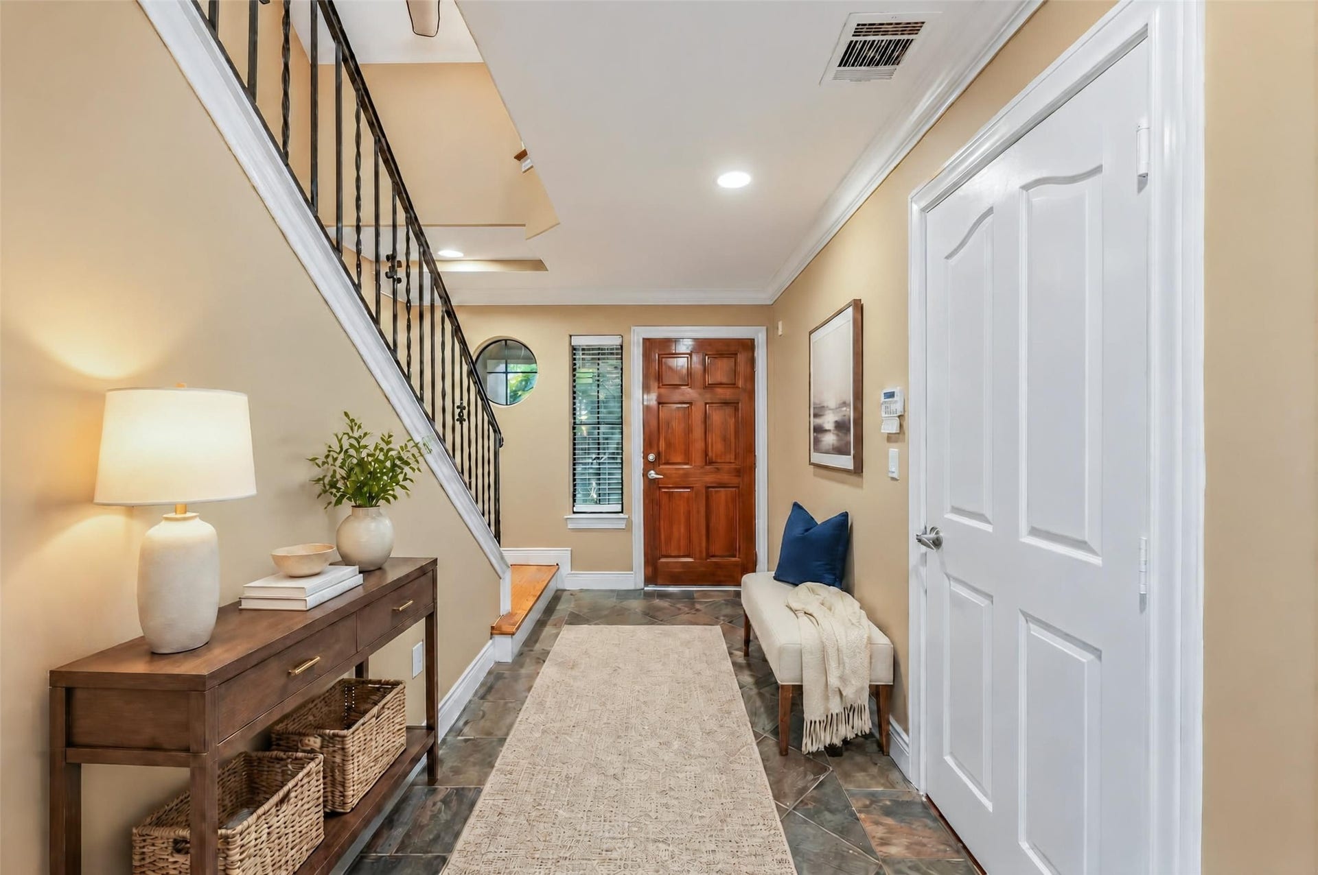 2604 Chenevert Street, Houston, TX 77004 The front room of the home with a garage door entrance - Virtually staged