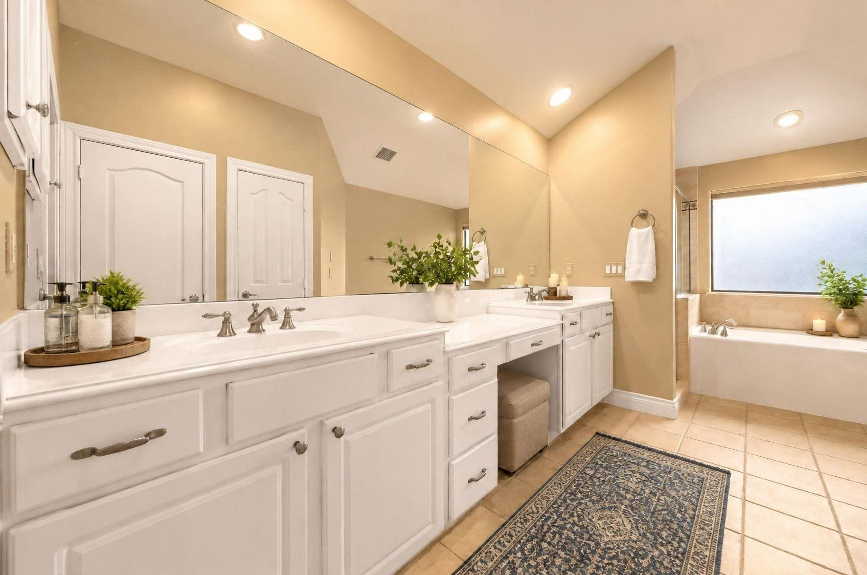 2604 Chenevert Street, Houston, TX 77004 The primary en suite with a large vanity, double sinks, and sitting area. Enjoy getting ready in this spacious bathroom! - Virtually staged